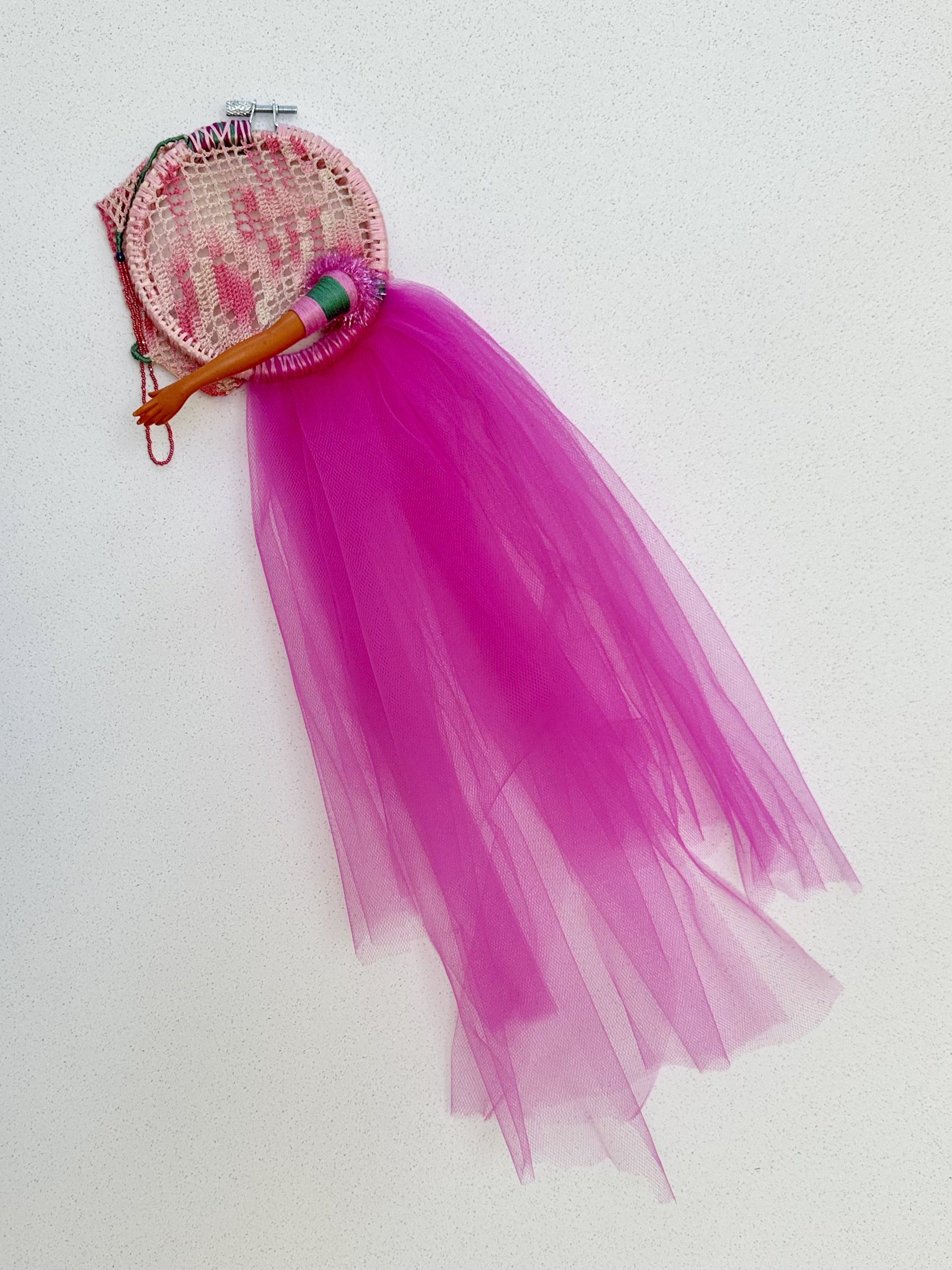 Striving for Grace (2024) embroidery thread, trim, and beads on vintage crocheted lace with upcycled tulle and plastic doll arm 20" x 9" x 2" $