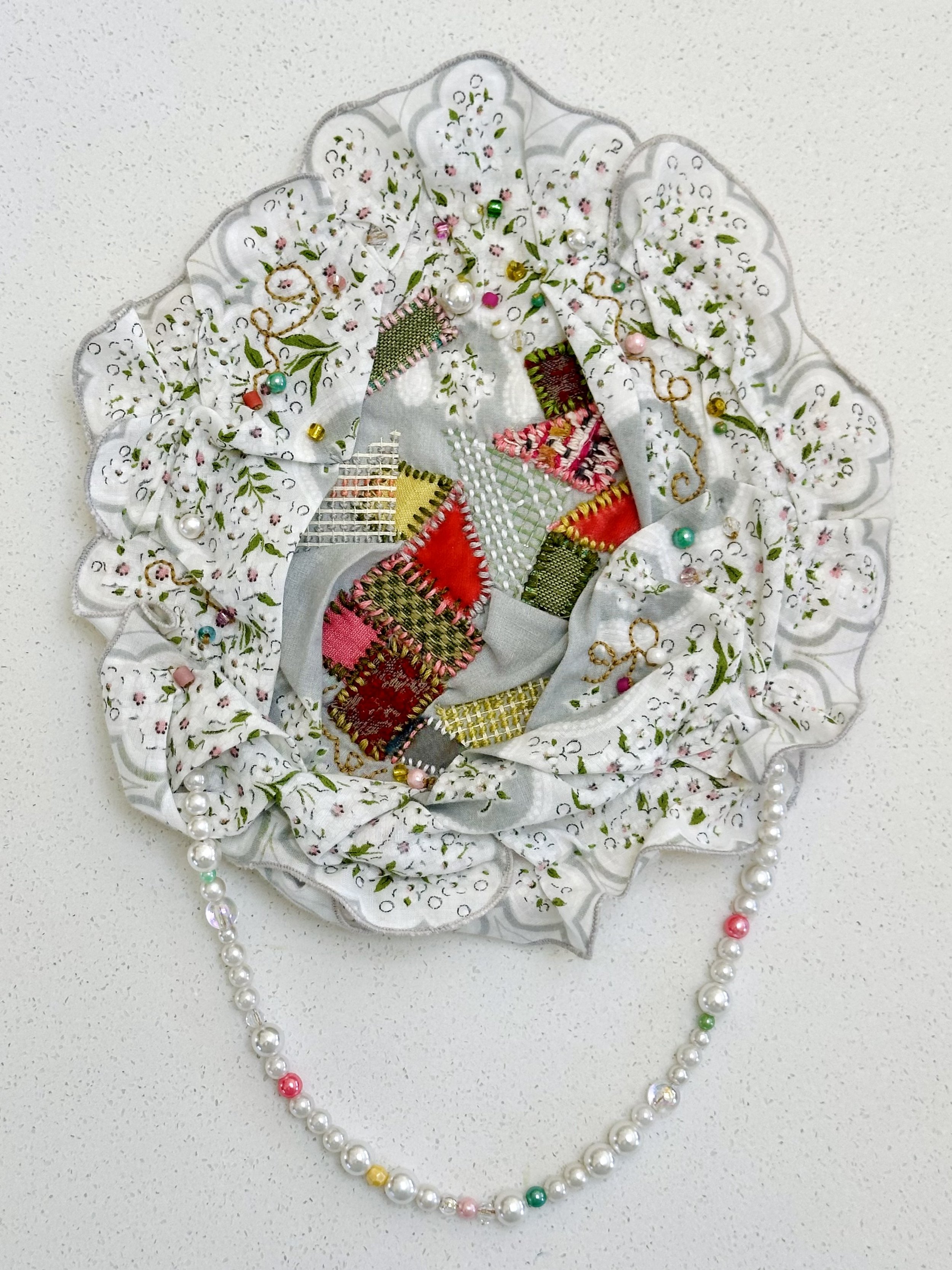 Sentiment, Etiquette, & Rage (2024) Sashiko thread, embroidery thread, upcycled fabric, mesh, "pearls", and beads on sentimental vintage handkerchief 12" x 8" not available