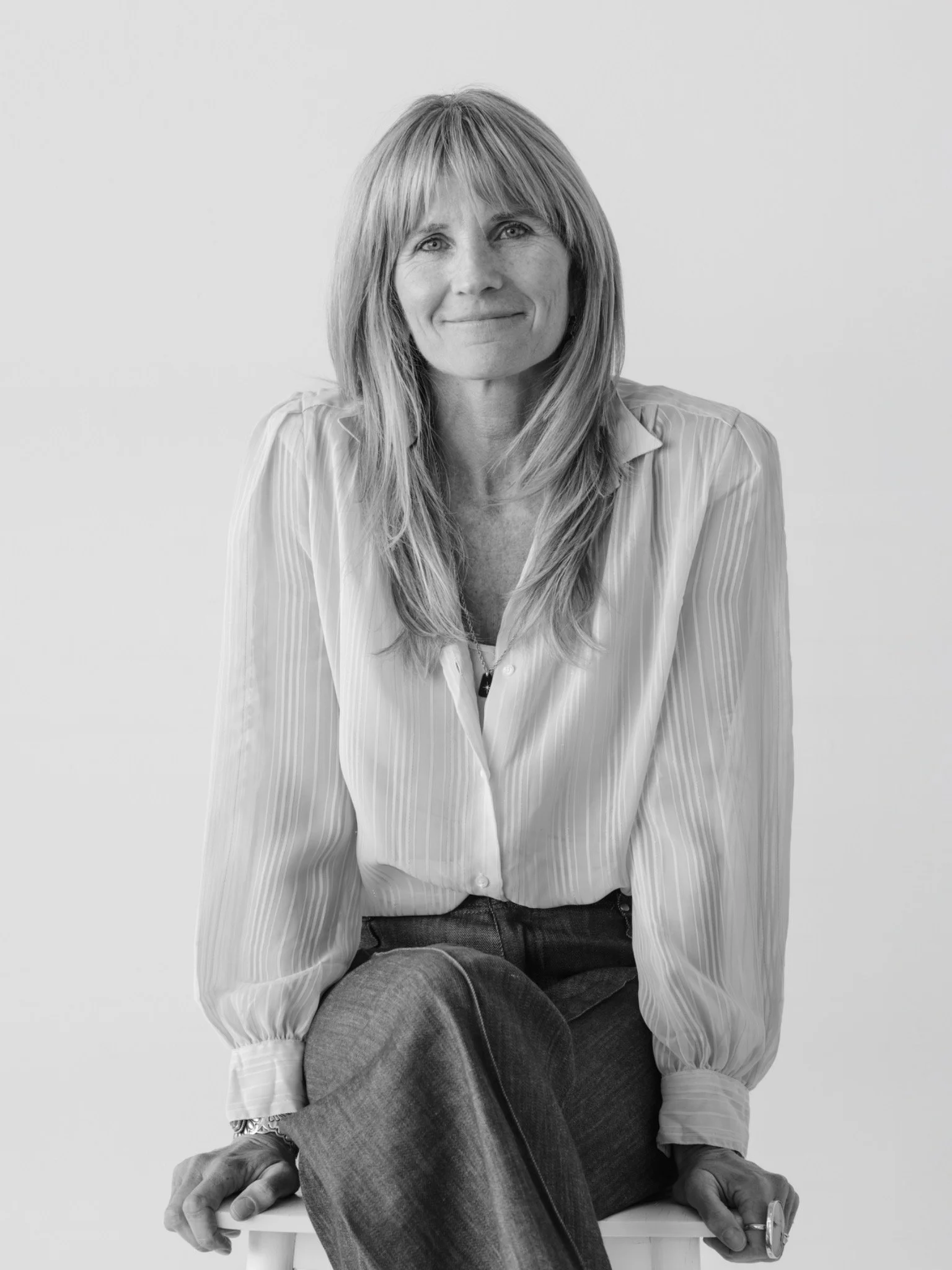 Kate Kripke seated in a white blouse, black and white portrait