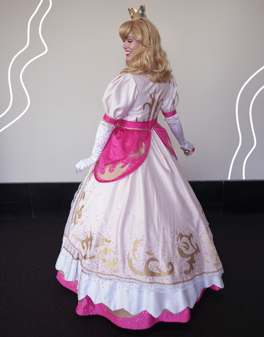Princess Peach cosplay against a plain backdrop, showing off the sparkles and layers of the costume at PAX East 2026.