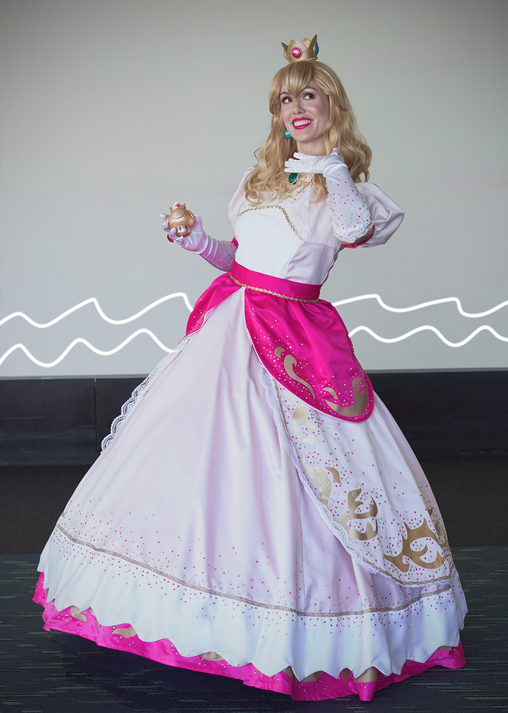 Princess Peach cosplay against a plain backdrop, showing off the sparkles and layers of the costume at PAX East 2026.