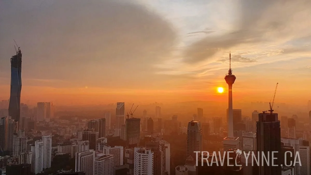 The sunset casts shades of orange onto Kuala Lumpur's skyline, including Merdeka 118 and the KL Tower, from Vertigo rooftop in the Banyan Tree Hotel KL.