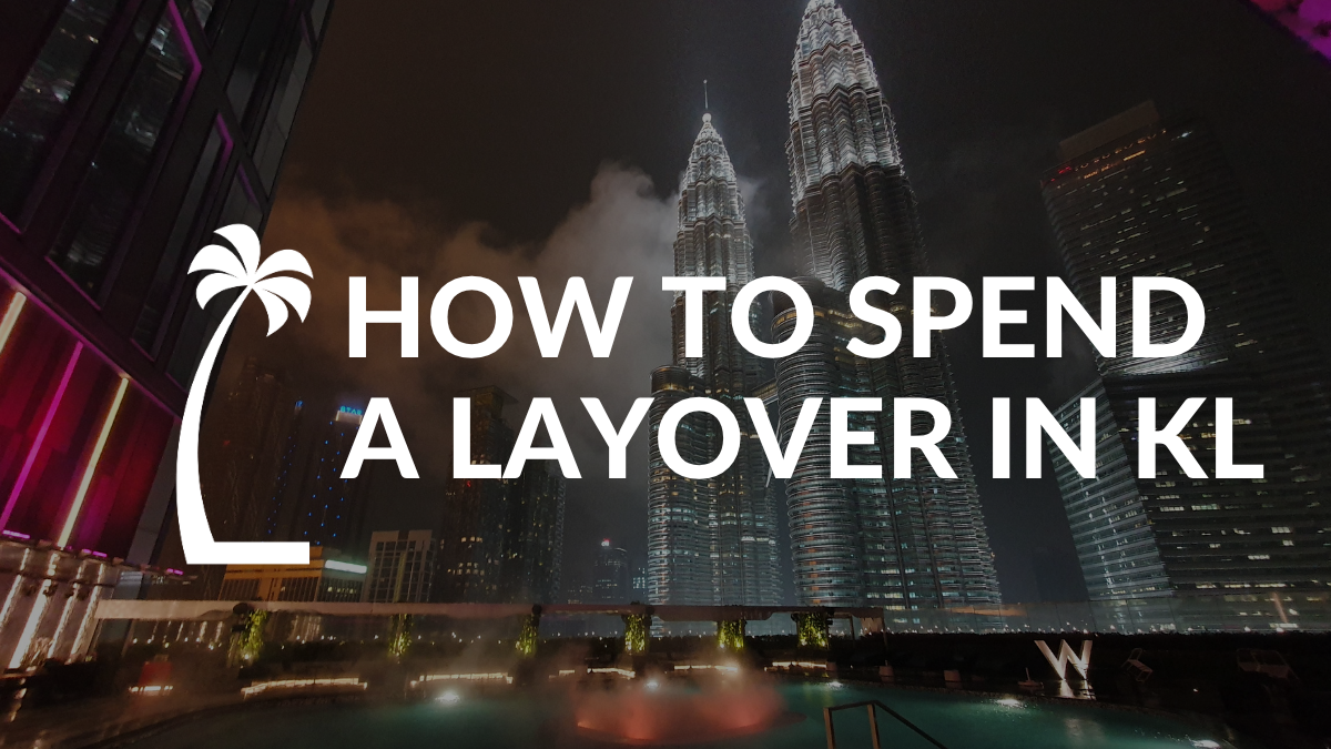 "How to Spend a Layover in Kuala Lumpur" on a background image of the Petronas Twin Towers lit up at night in a cloudy grey and black sky from a bar with a pool