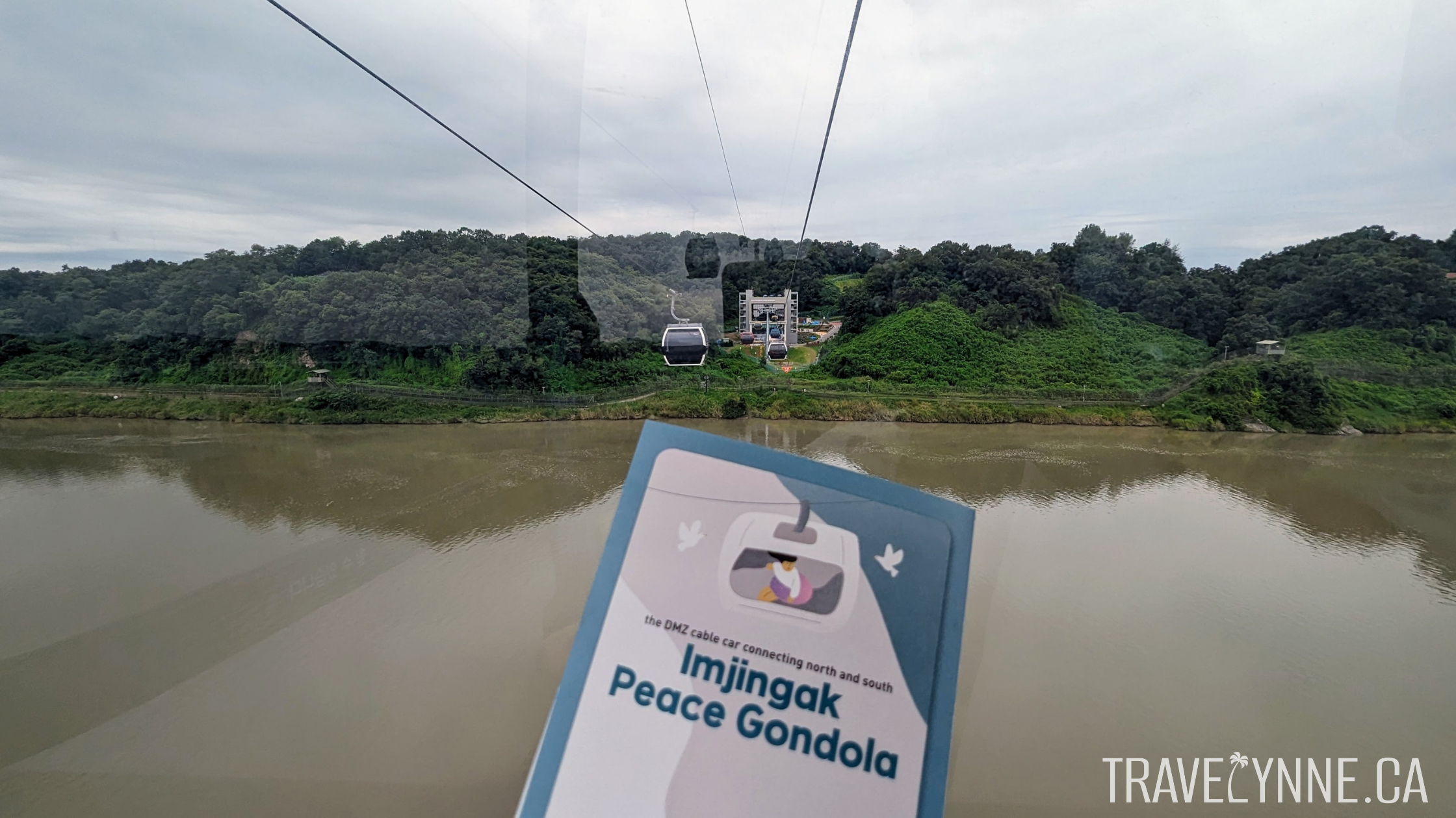 A flyer reads "The DMZ cable car connecting north and south - Imjingak Peace Gondola" with the Imjin River in the background.
