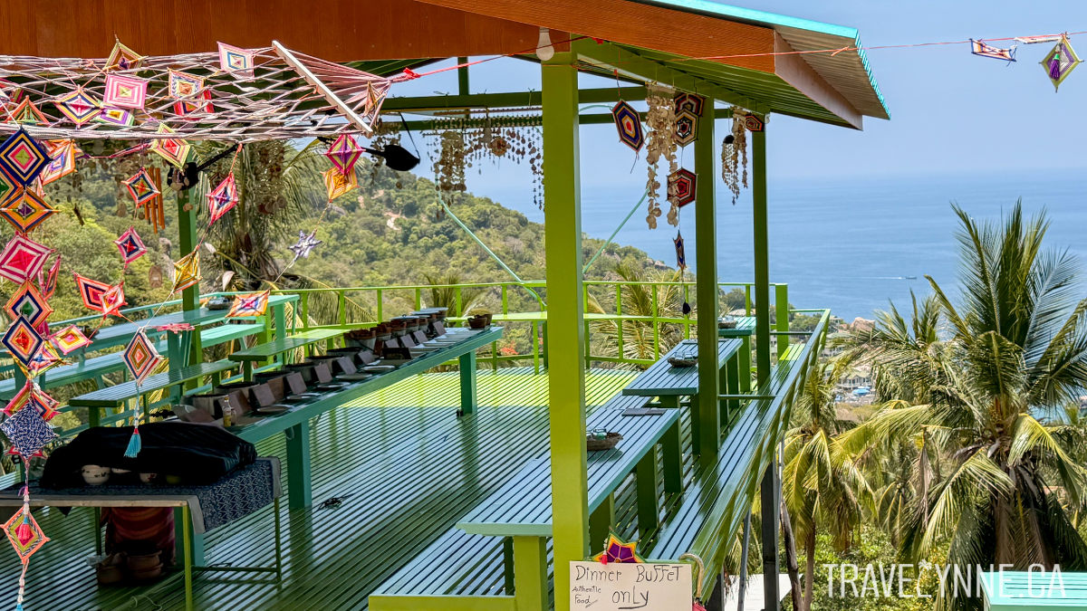 A grren deck perches over the jungle below with the ocean in clear view, housing the Sun Moon Restaurant buffet in Koh Tao.