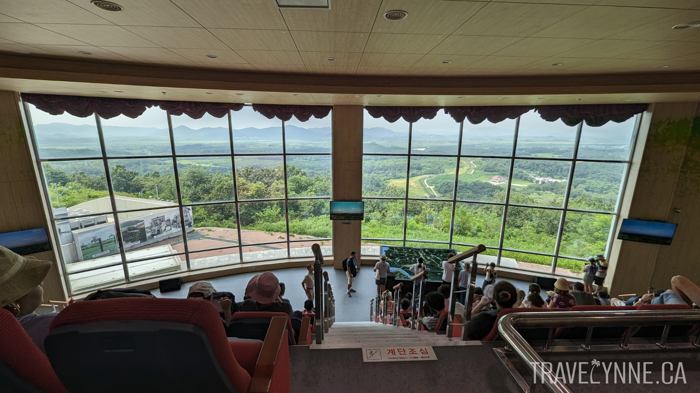 Inside Dora Observatory, a giant window in a theatre room overlooks lush landscapes in North Korea.