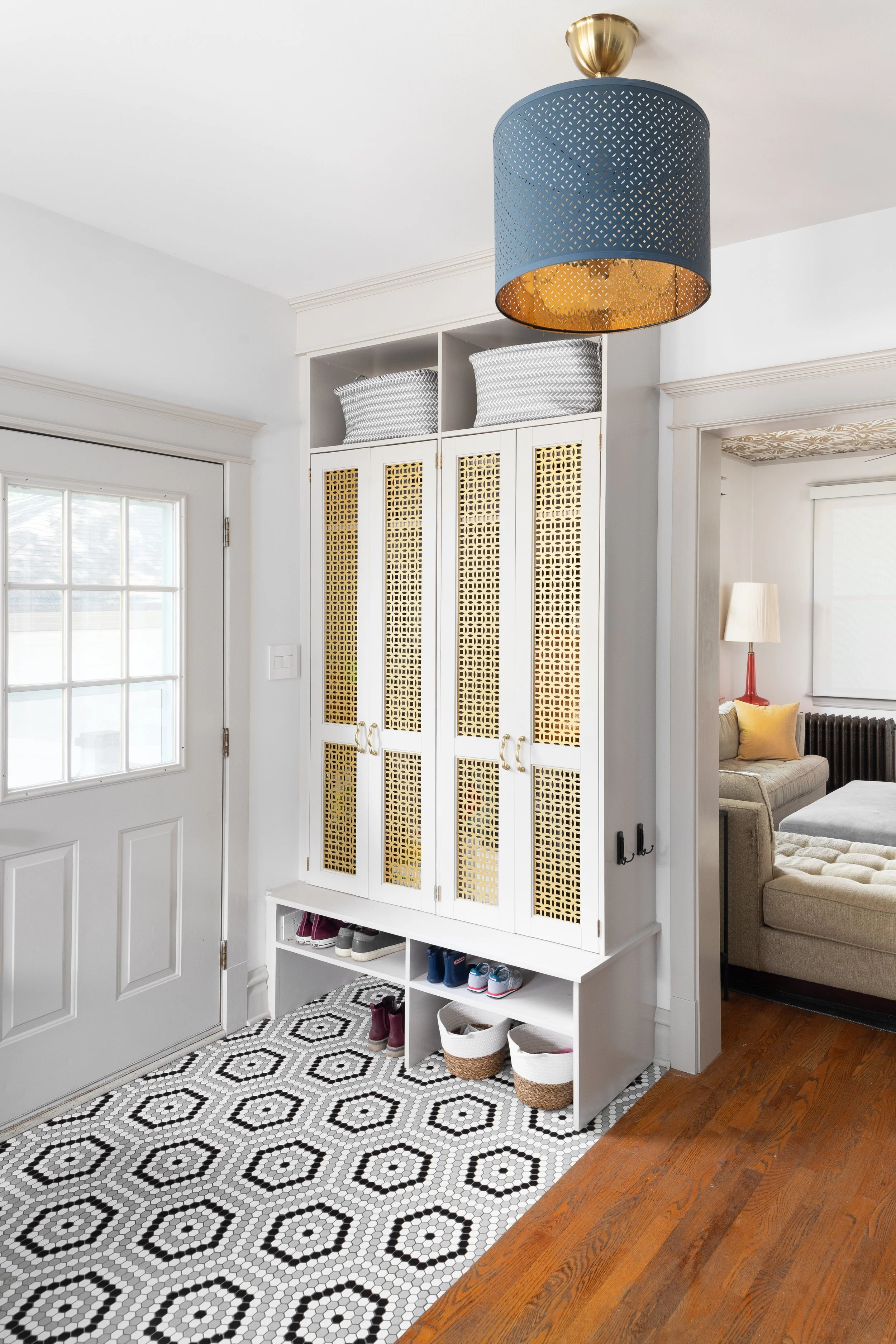 Light gray mudroom cabinet geometric floor tile gold metal inlay