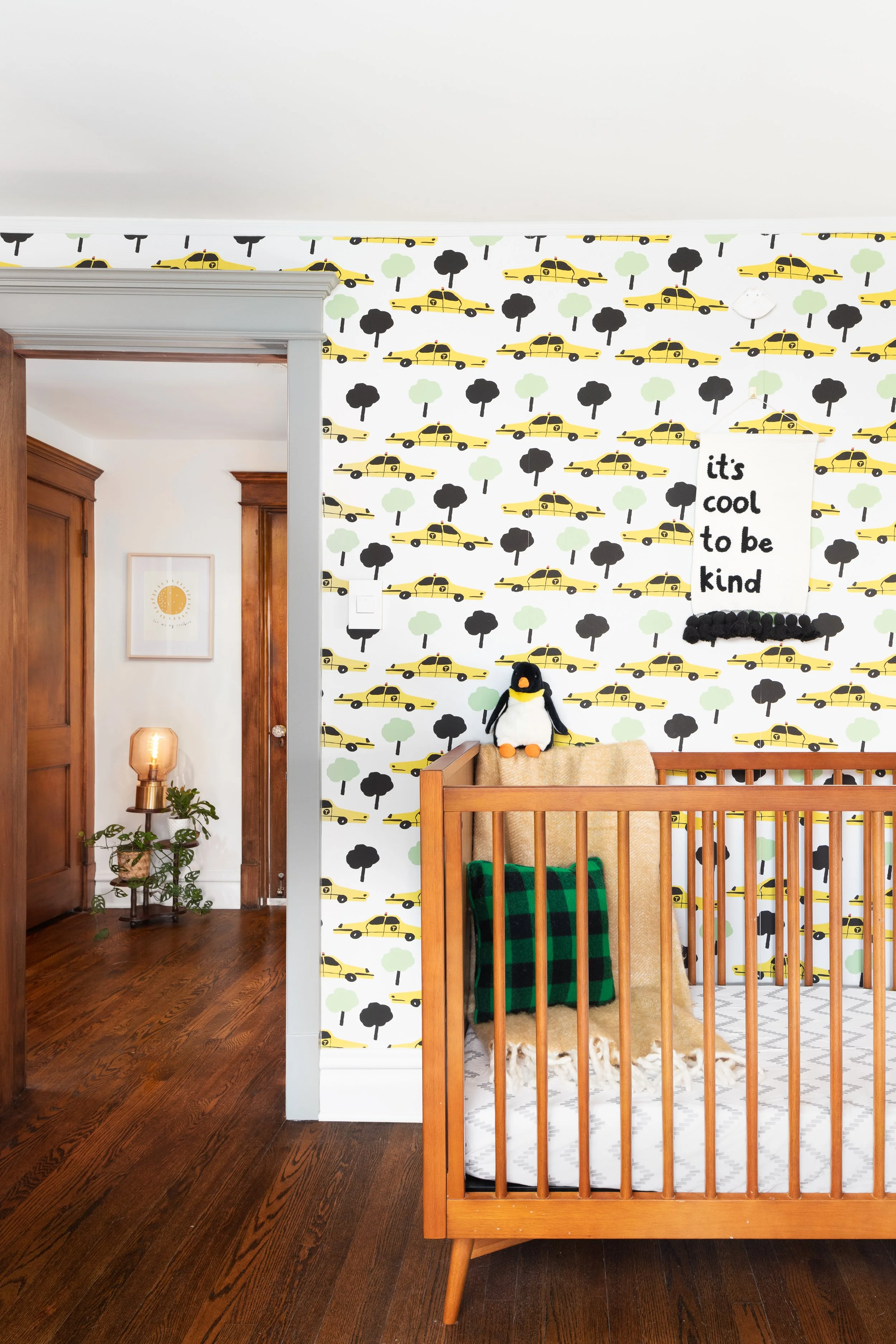Children's room walnut crib and taxi cab wallcovering