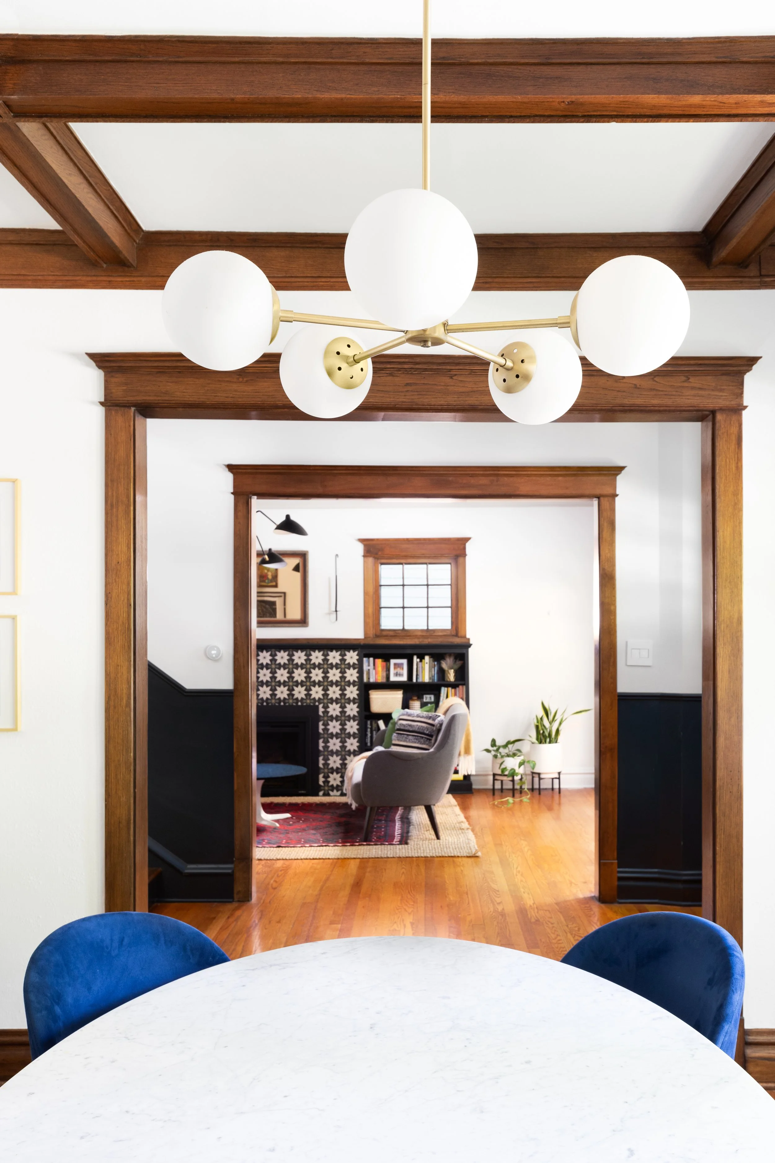View from dining into living area circular light fixture