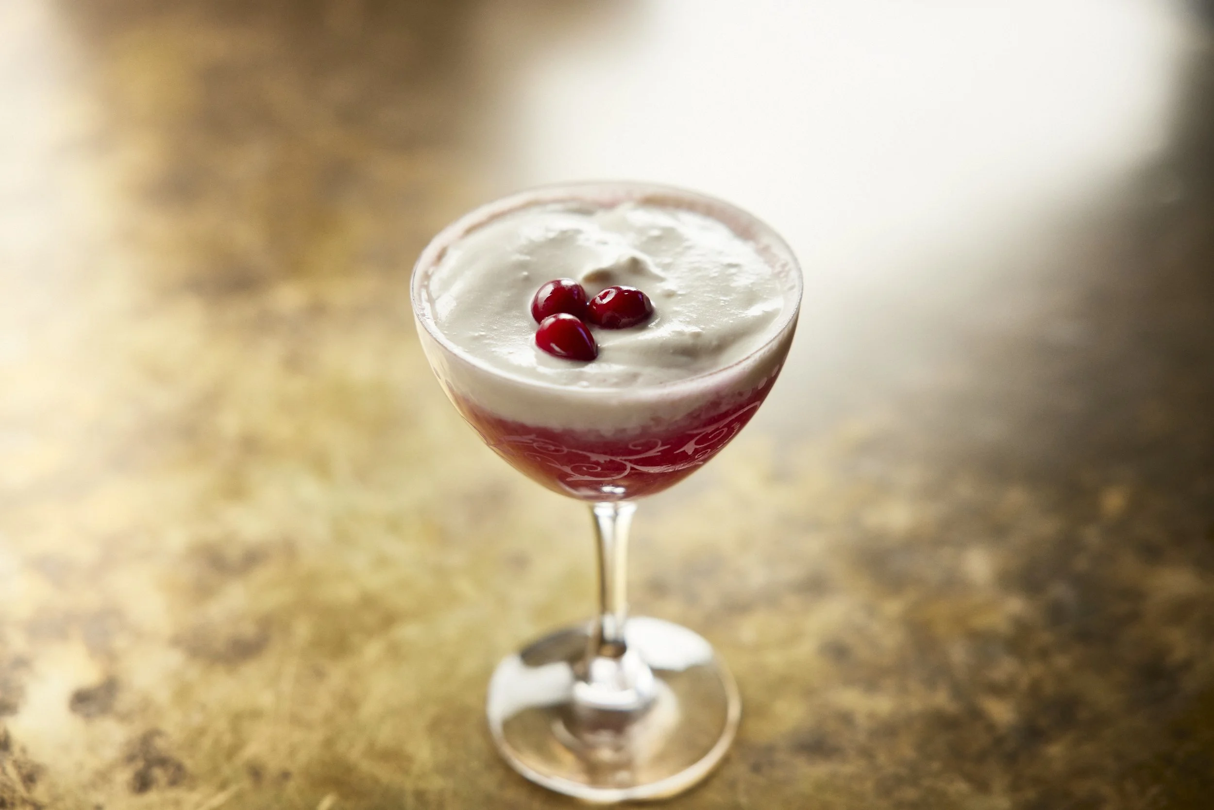 Cranbrosia, a cranberry and cream cheese cold foam cocktail