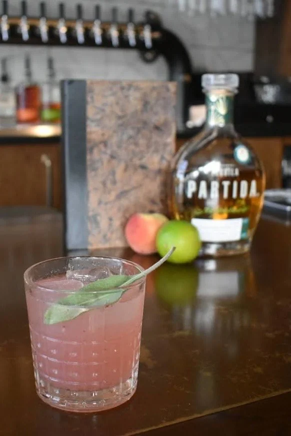 the pink color of this cocktail is 100% from a fresh muddled peach