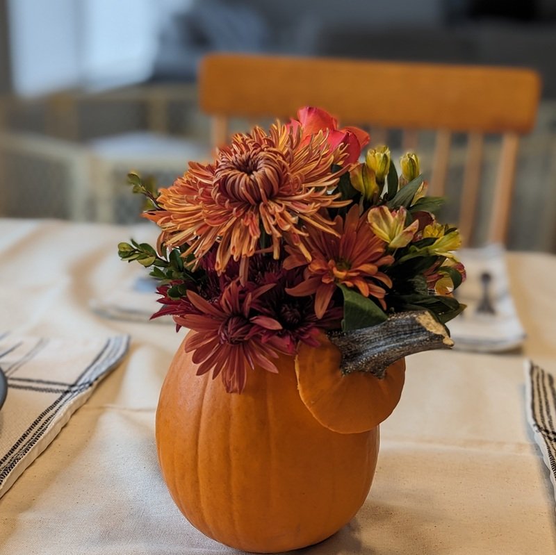 fall flowers arranged in a pumpkin