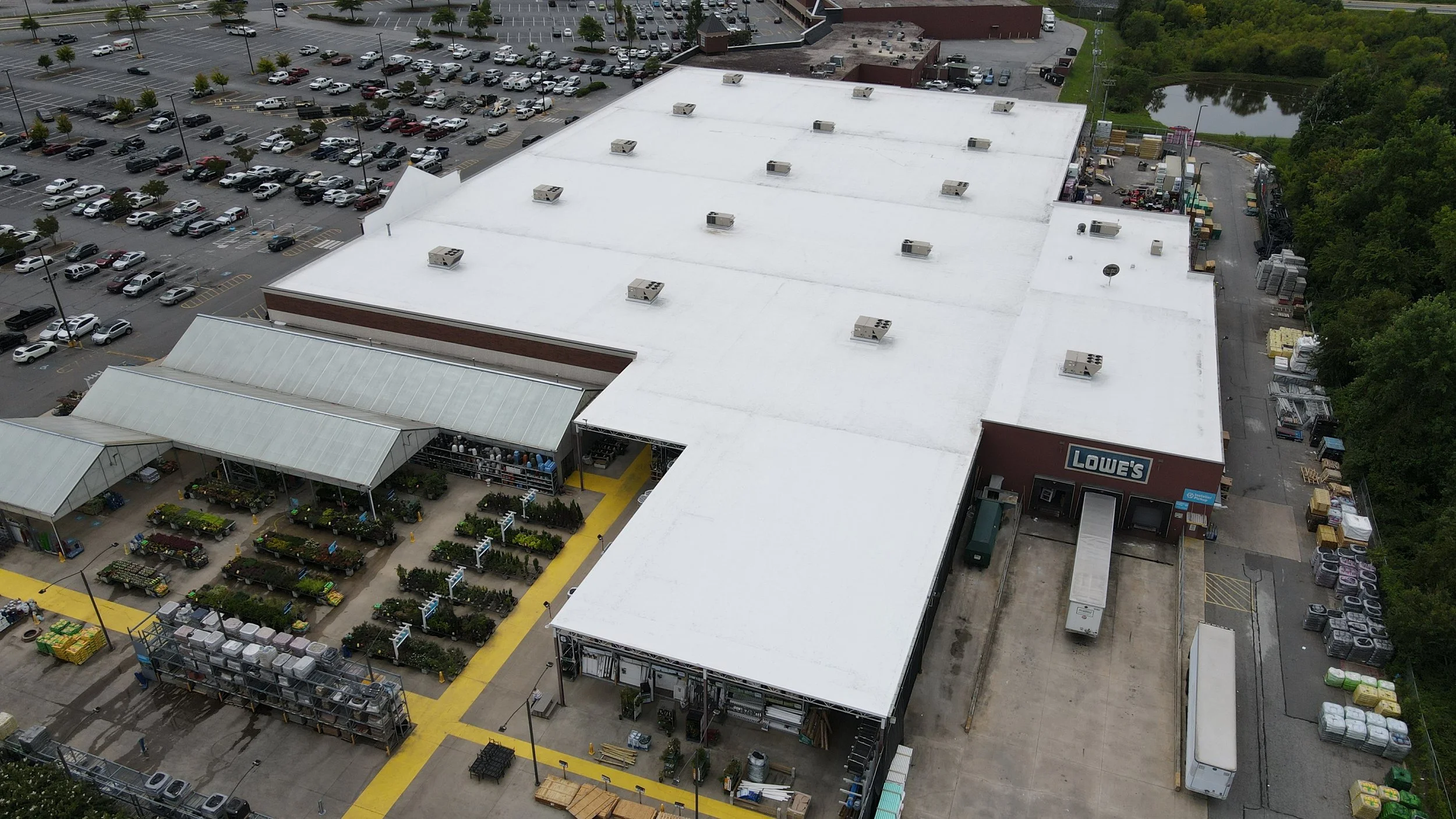 Aerial view of Lowe's hardware store with gardening section, parking lot, and surrounding area.
