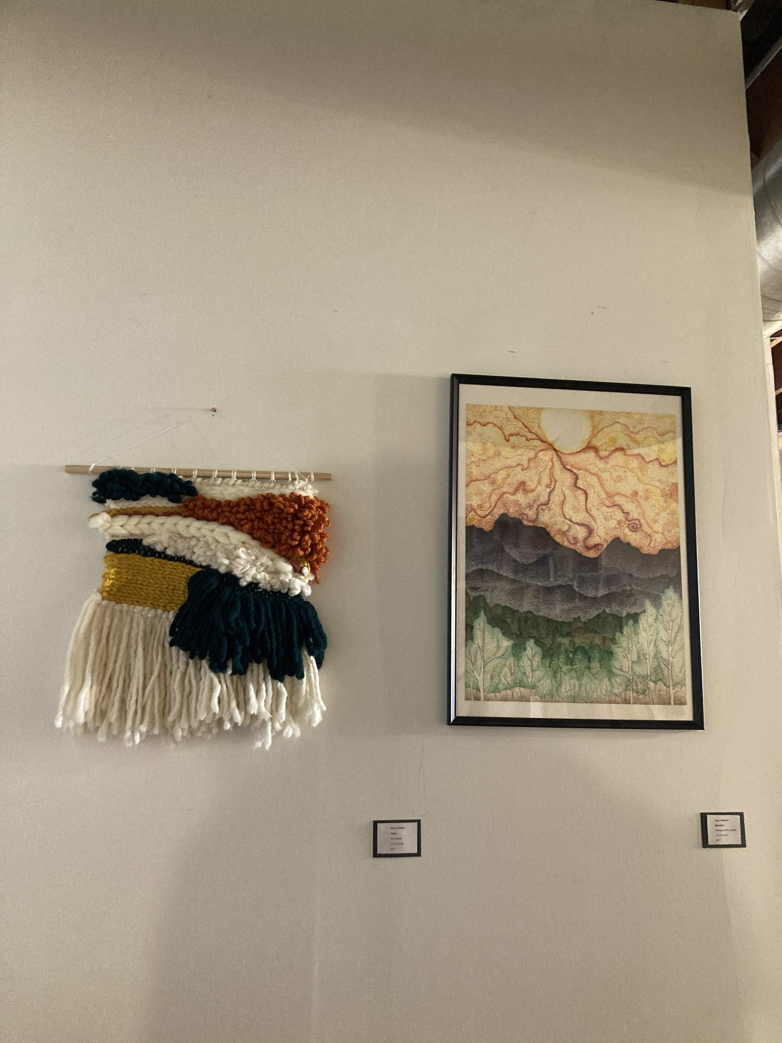 My artwork mountains on the right next to a textile artwork on the left