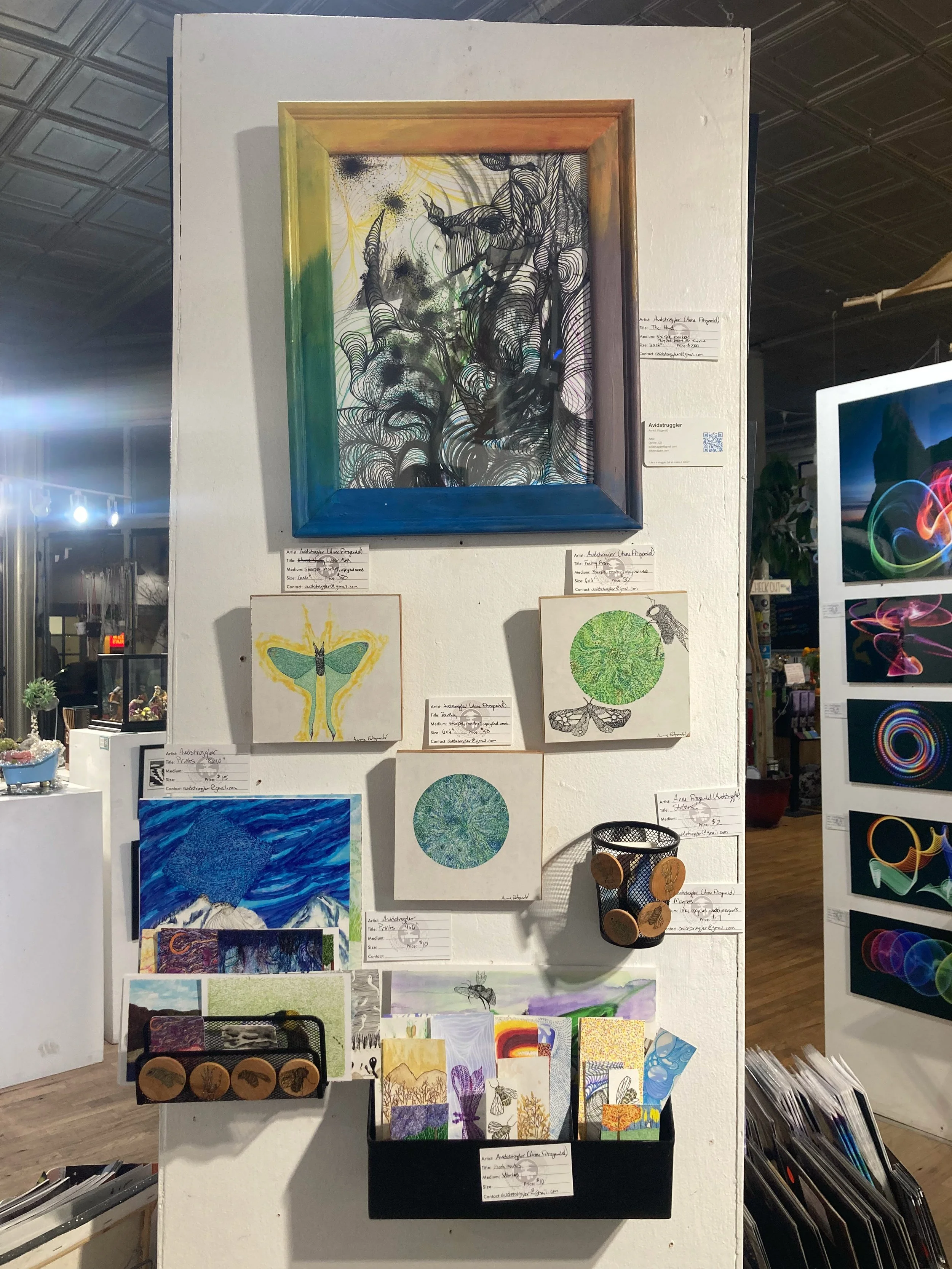 Close-up of a small art gallery wall covered in art.