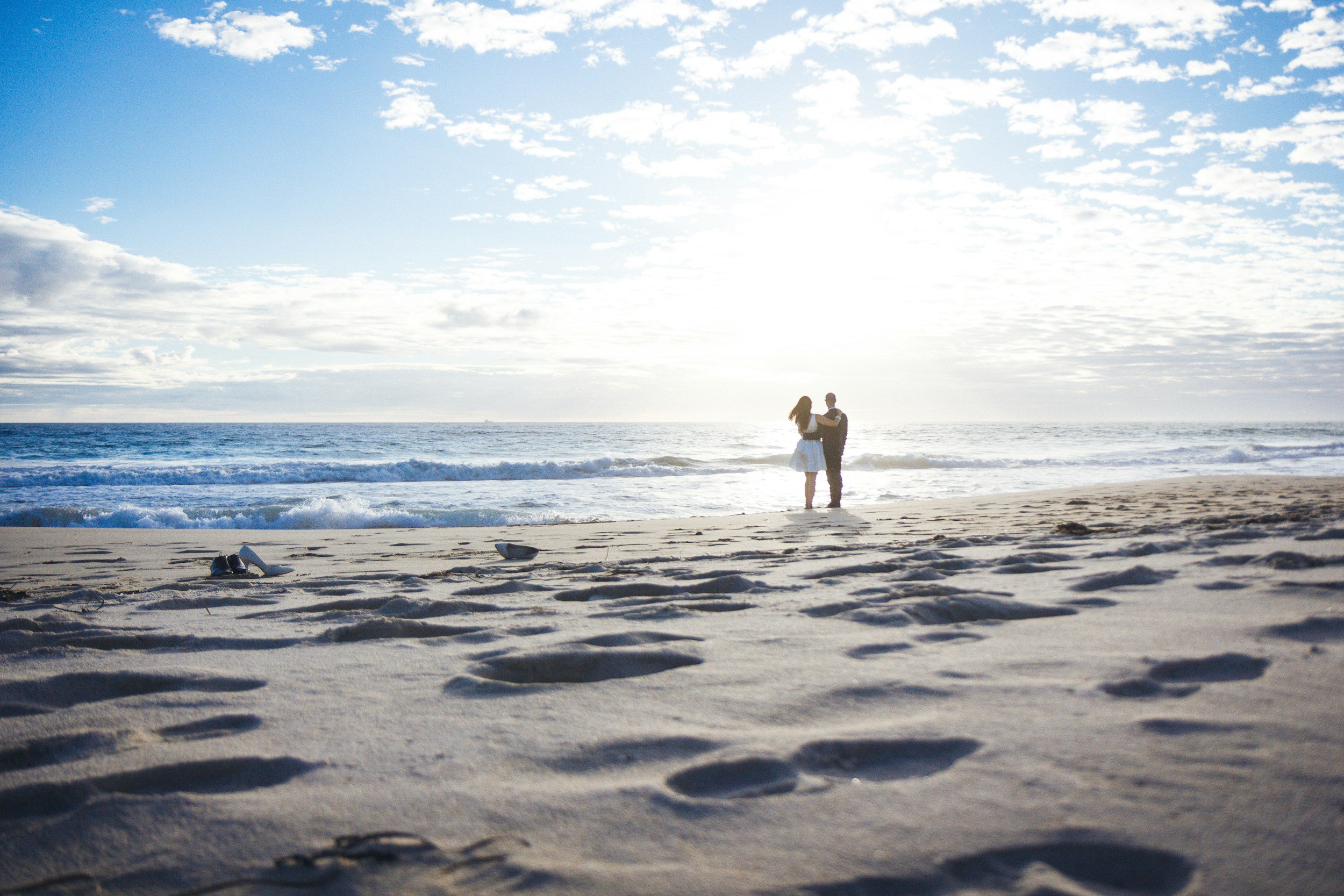 Couple walking together on beach during online couples therapy journey