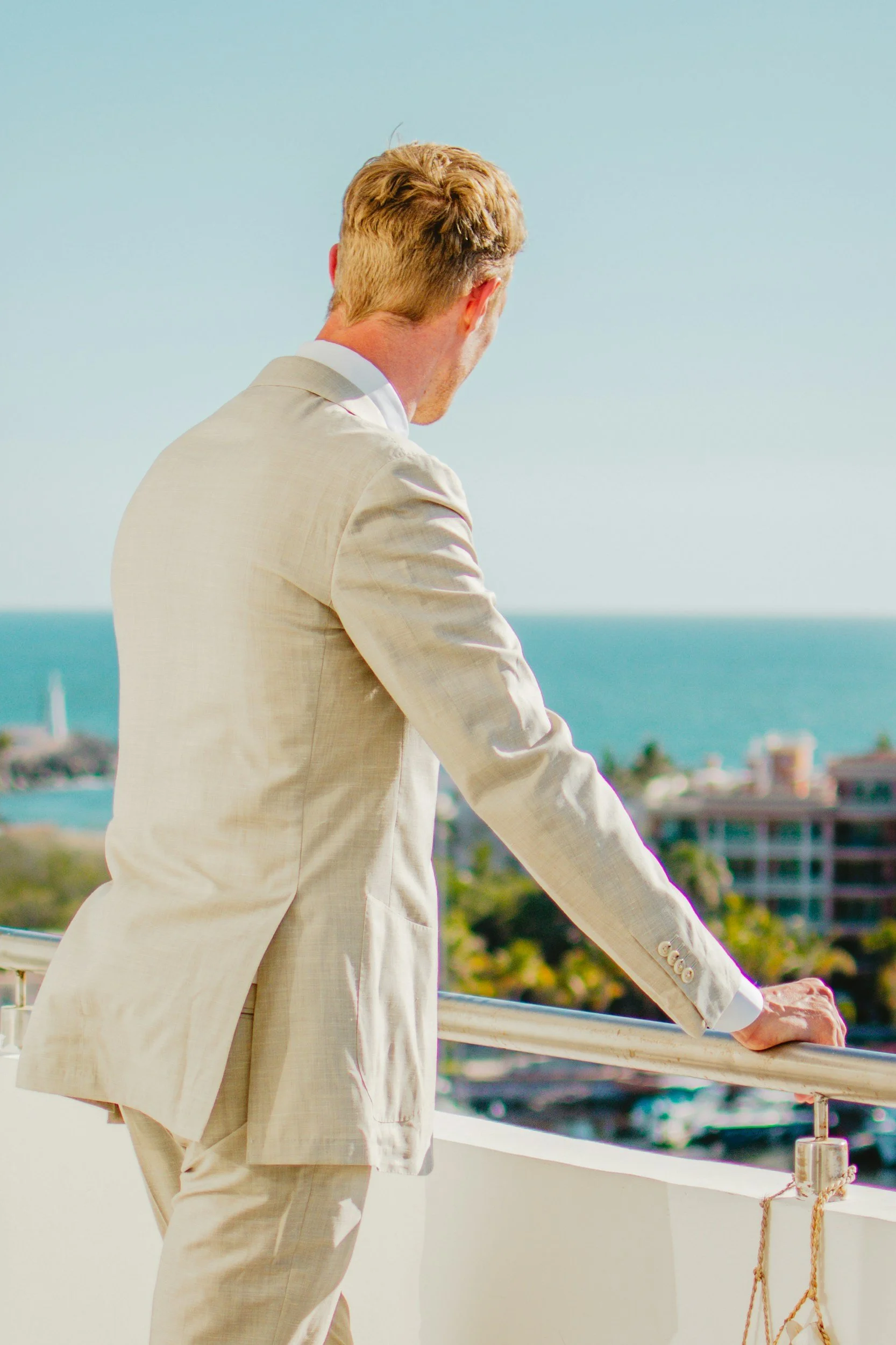 Man in suit looking out over Tampa Bay representing men's therapy at It Begins Within Healing Center