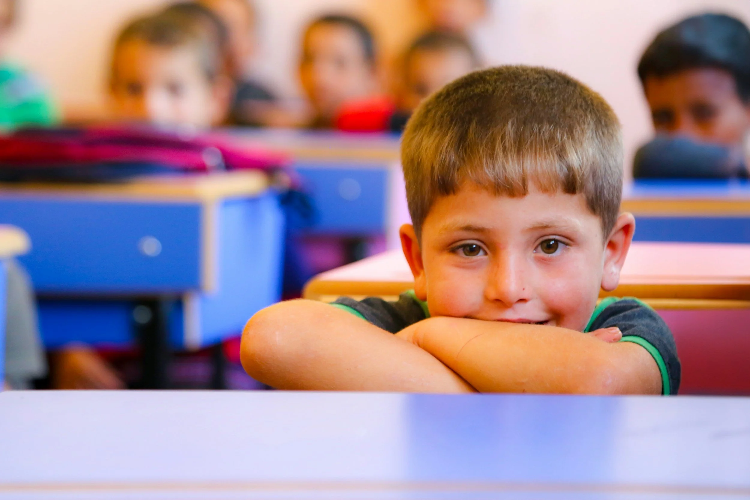 Young boy at a classroom desk reflecting ODD school behavior assessment