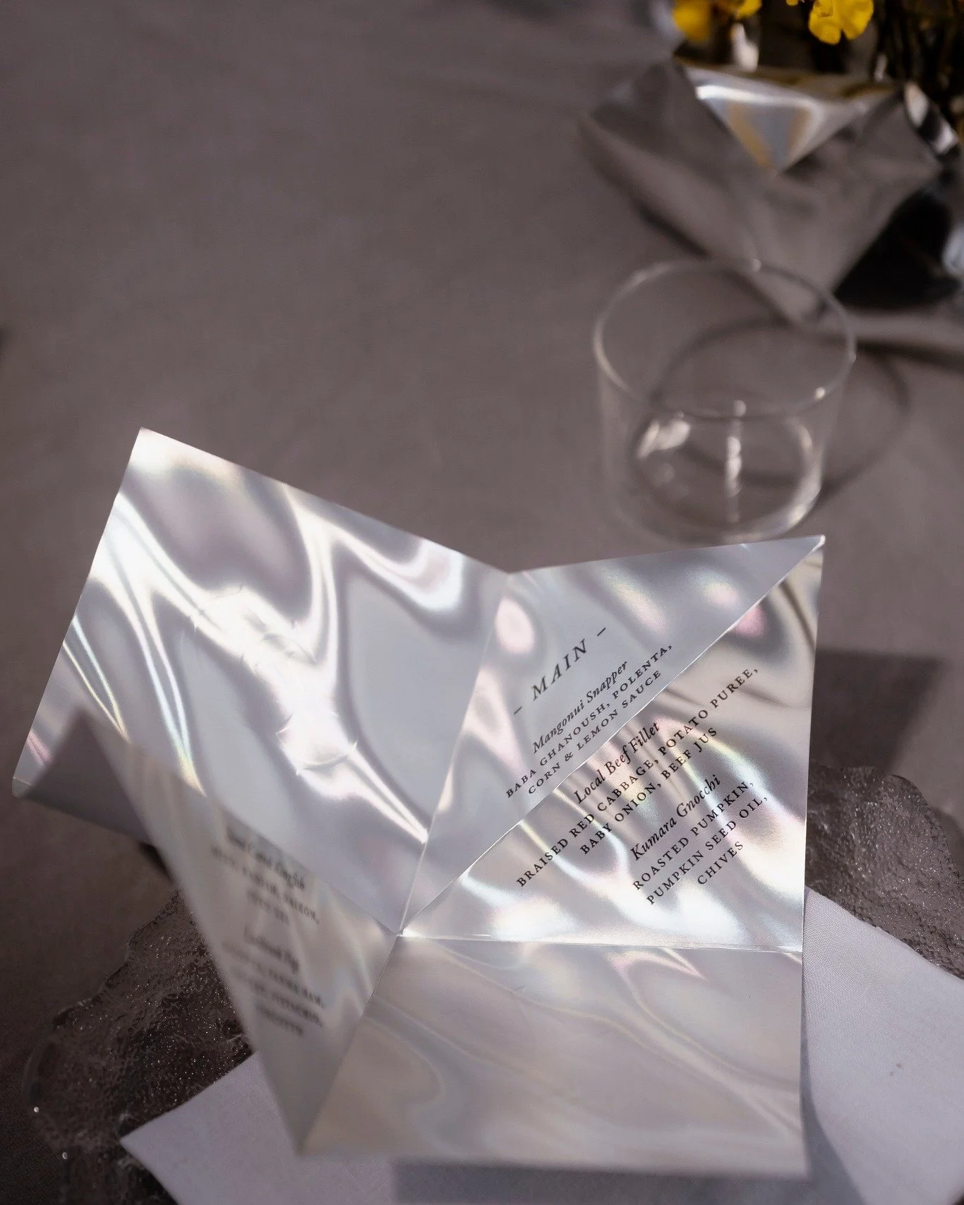 This stunning holographic paper and a simple fold really brings a whole new dimension to the table and reflects the ocean setting. Custom dinner menus, functional and beautiful ✨
~
Planning &amp; production @alexandrakatecreative 
Venue @rosewoodkaur