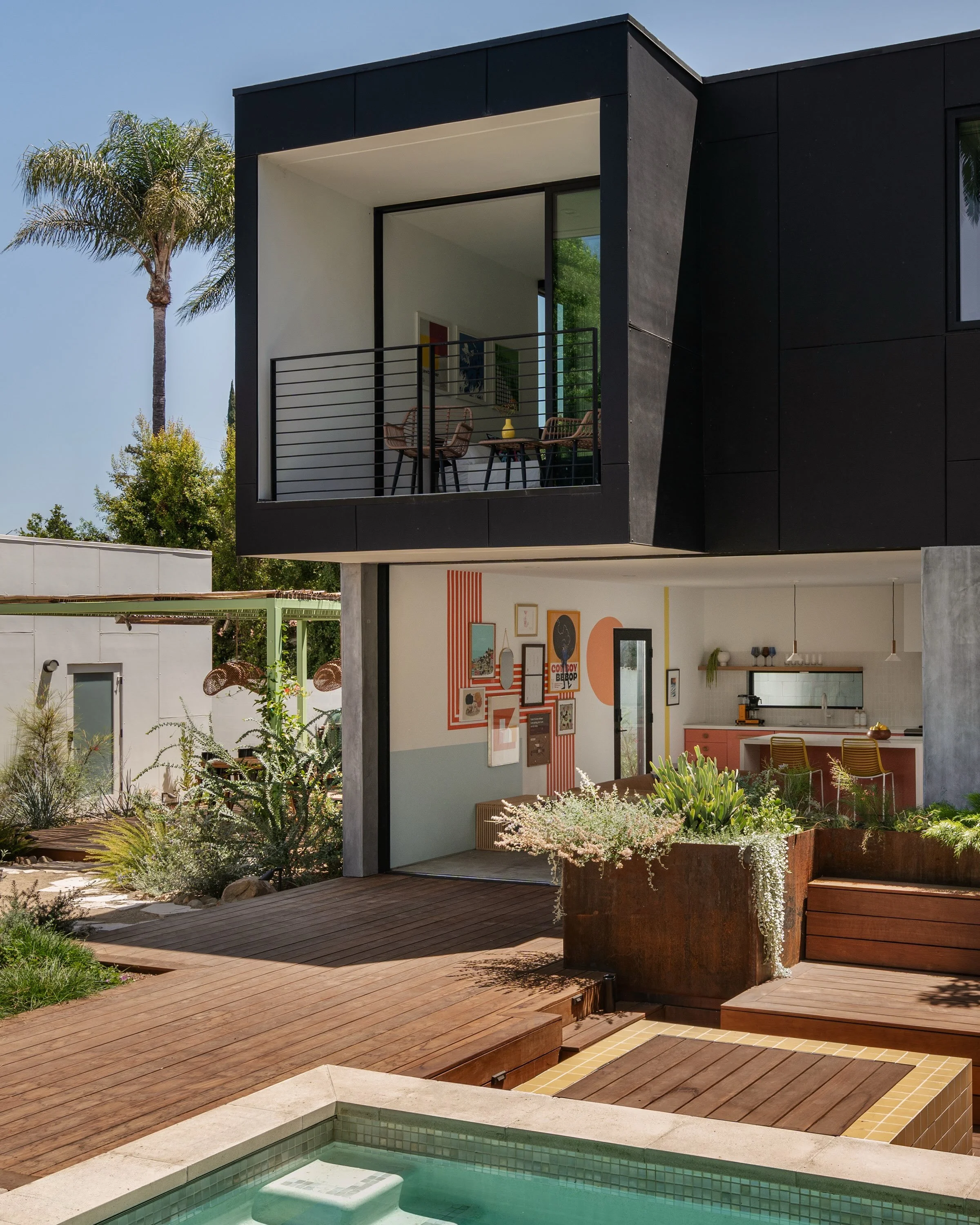 NEW WORK! Pocketing doors blur the lines between indoor and outdoor spaces for this 2-story ADU in Encino. Serving as home office, guest bedroom and entertainment hub, the backyard was transformed for quintessential SoCal living. The dark exterior ju