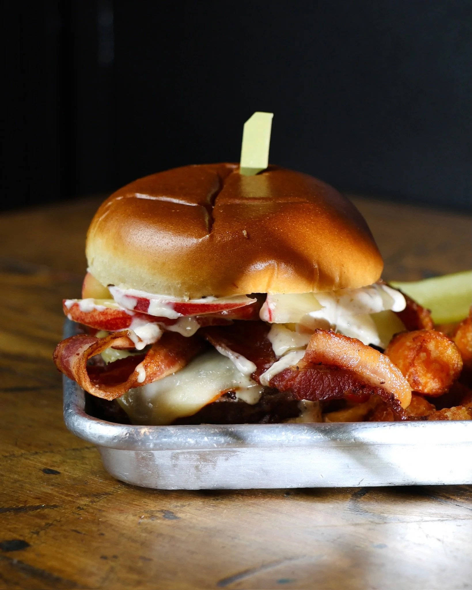🍏 Warning: This burger is seriously wicked! 

🍔 Our current Munchie of the Month, The Poison Apple, is the cure for your fall cravings! Featuring a wagyu patty, Muenster cheese, applewood smoked bacon, fresh apple slices, and our house-made apple c