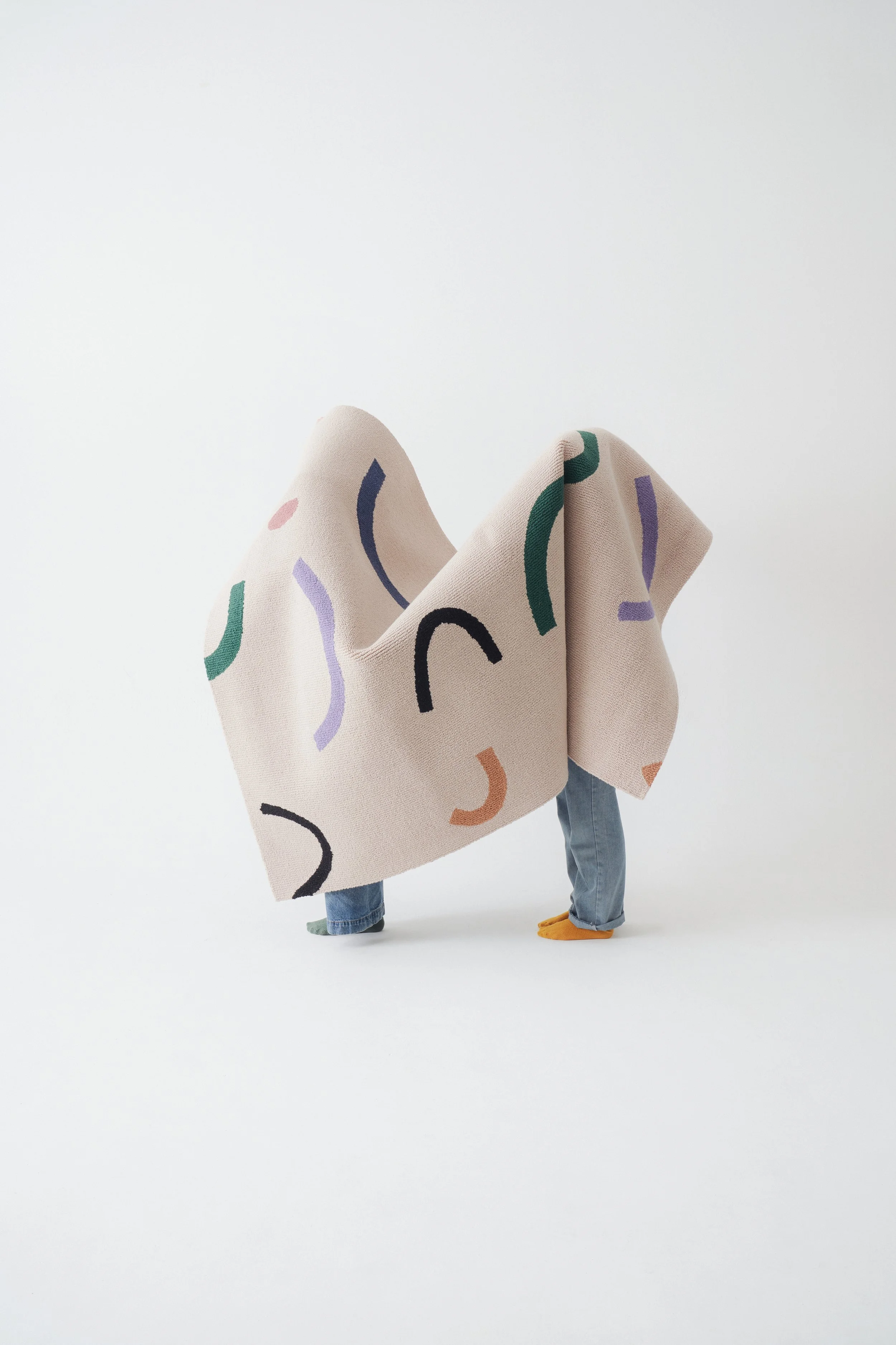 two people under a hand tufted rug