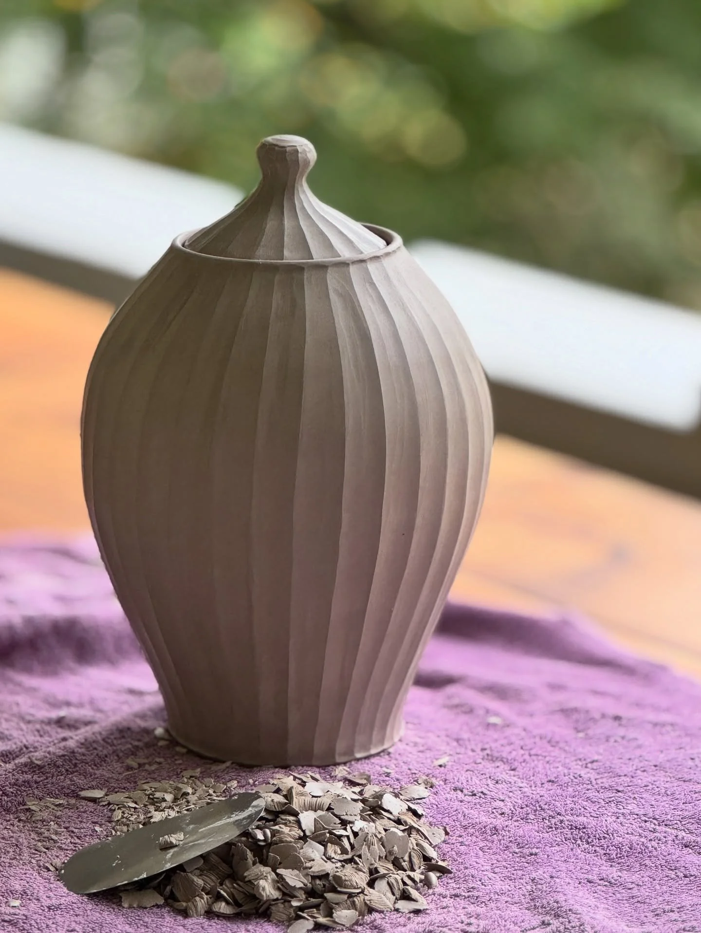 Bringing my studio outside to the porch today. The leaves are starting to turn here in western Massachusetts and I am enjoying the last of the beautiful flowers. This is a large urn that I am carving. Just the carving alone has taken me two hours. Th