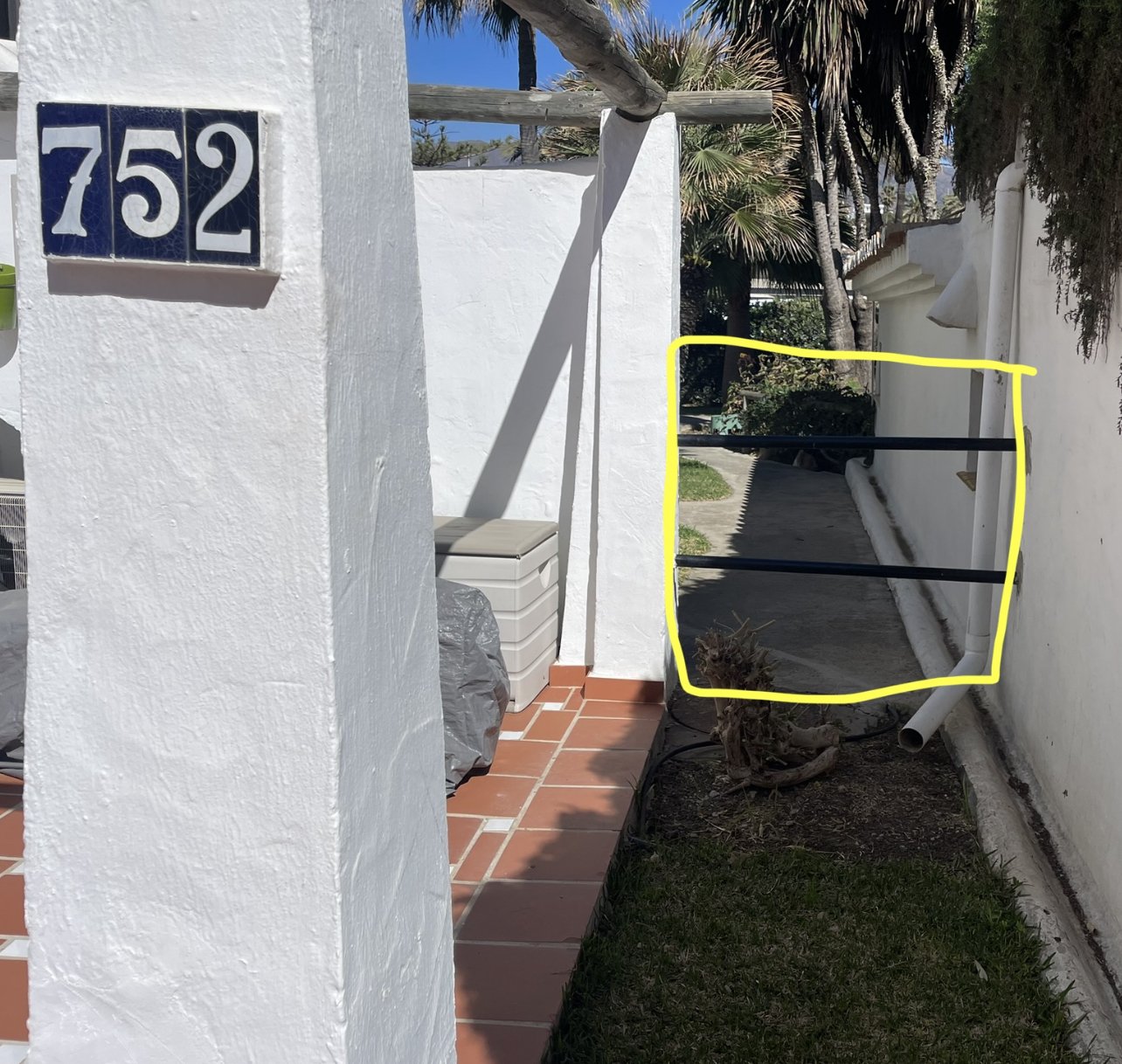 Metal bars restricting passage on a named path (Camino de Ronda)