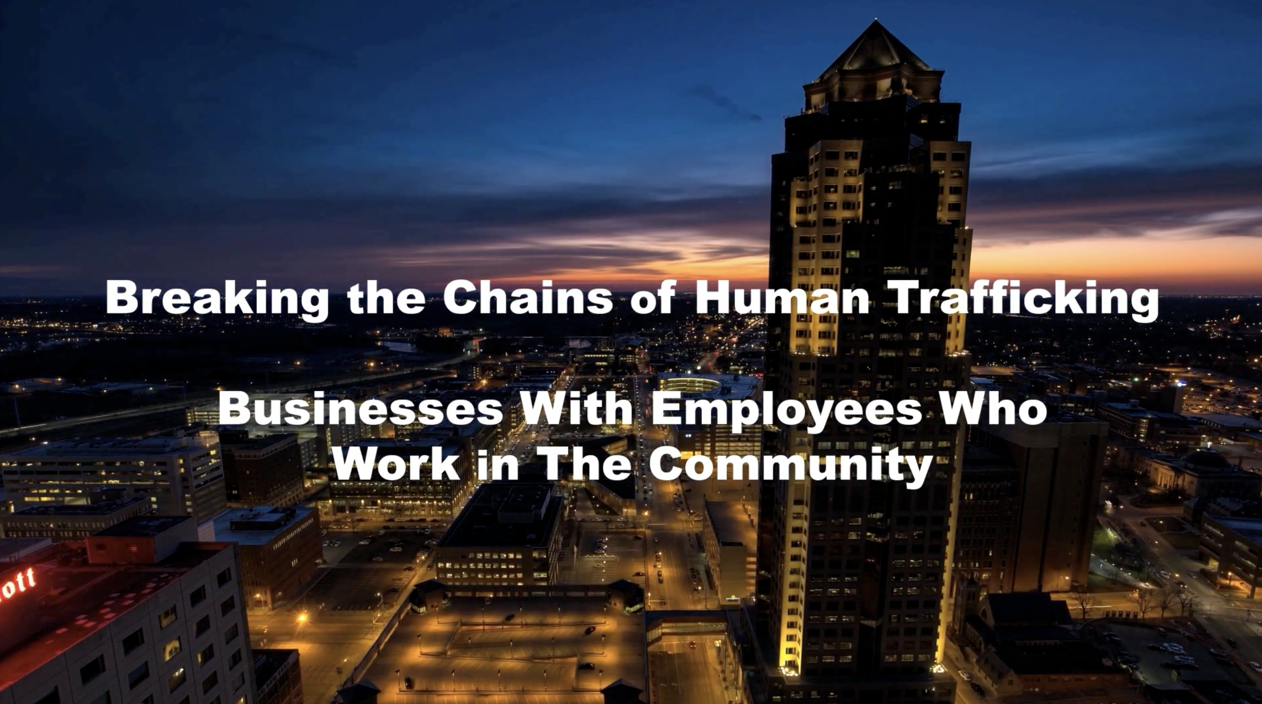 Nighttime cityscape with tall building and illuminated streets overlaid with text about breaking human trafficking chains and community work.