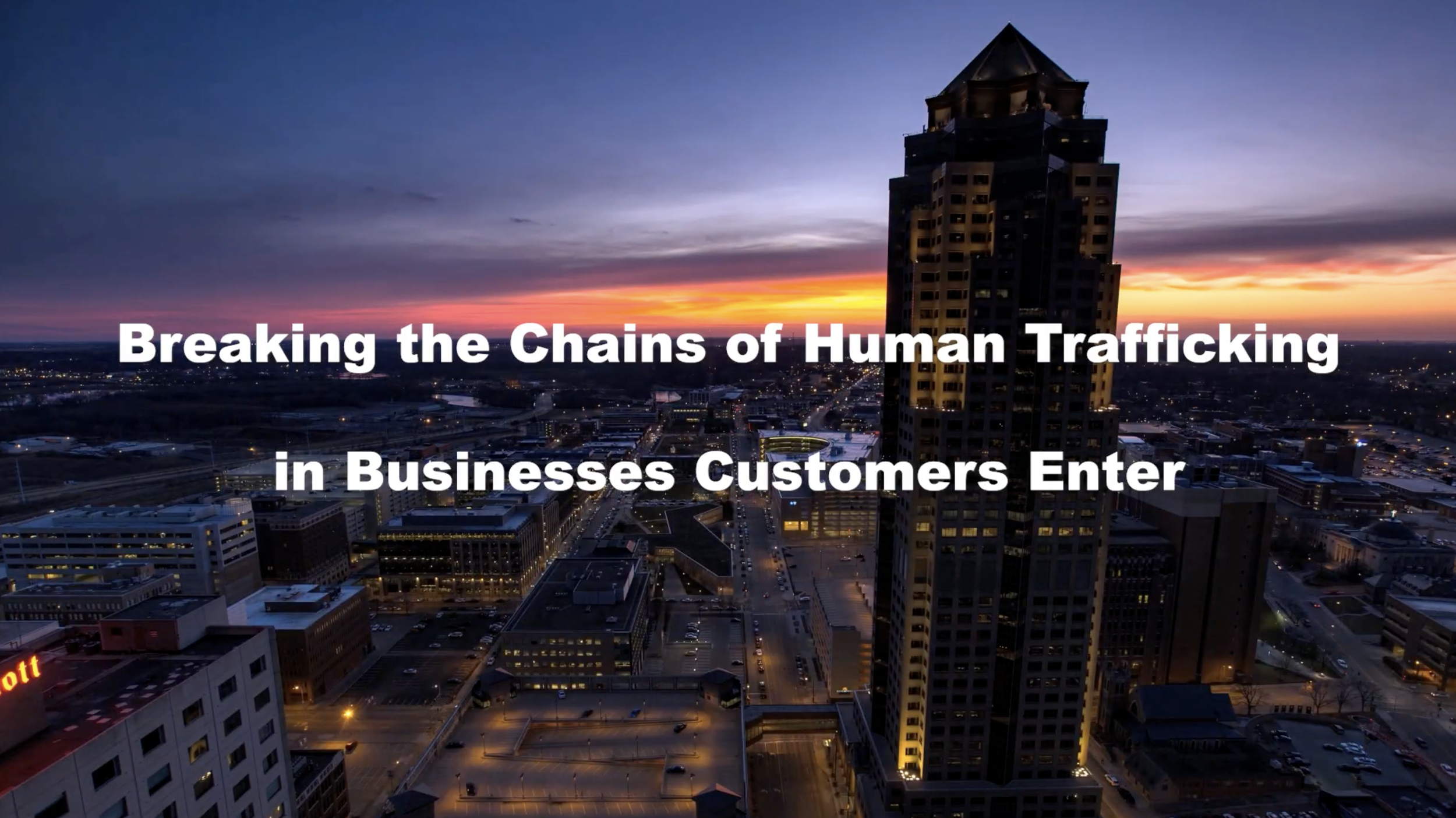City skyline at dusk with a tall building in the foreground and the sky with orange and purple hues, overlaid with the text "Breaking the Chains of Human Trafficking in Businesses Customers Enter."