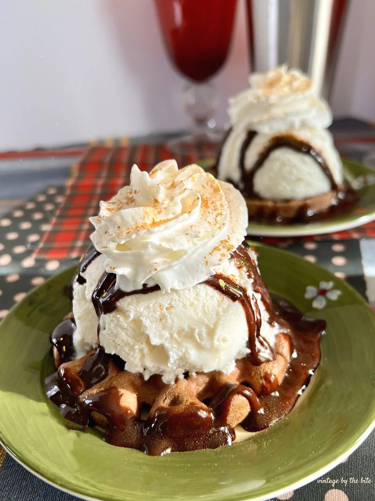 chocolate waffles covered in vanilla ice cream, chocolate syrup, whipped cream and a dusting of edible gold