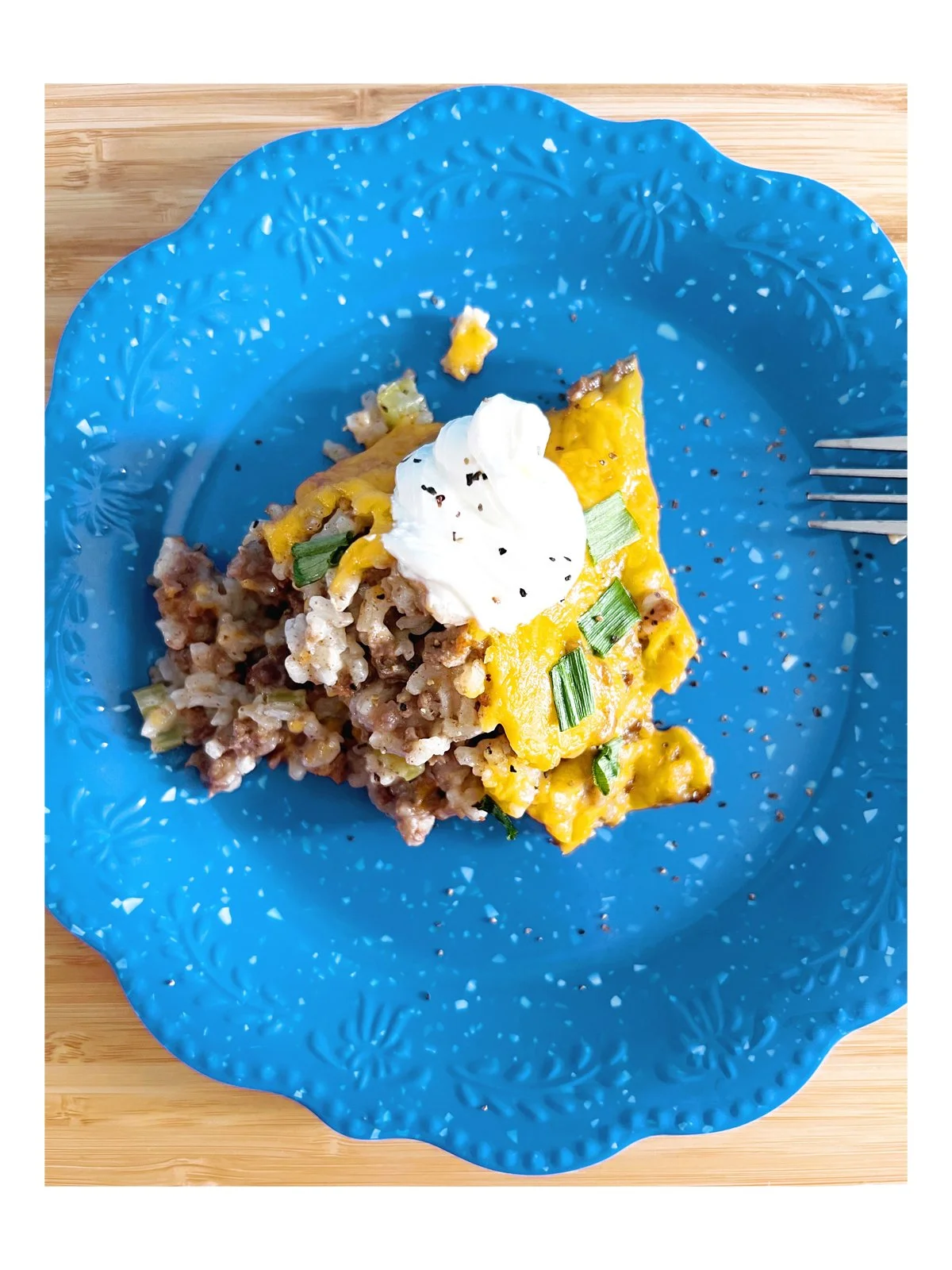 flatlay hamburger and rice casserole on a blue plate