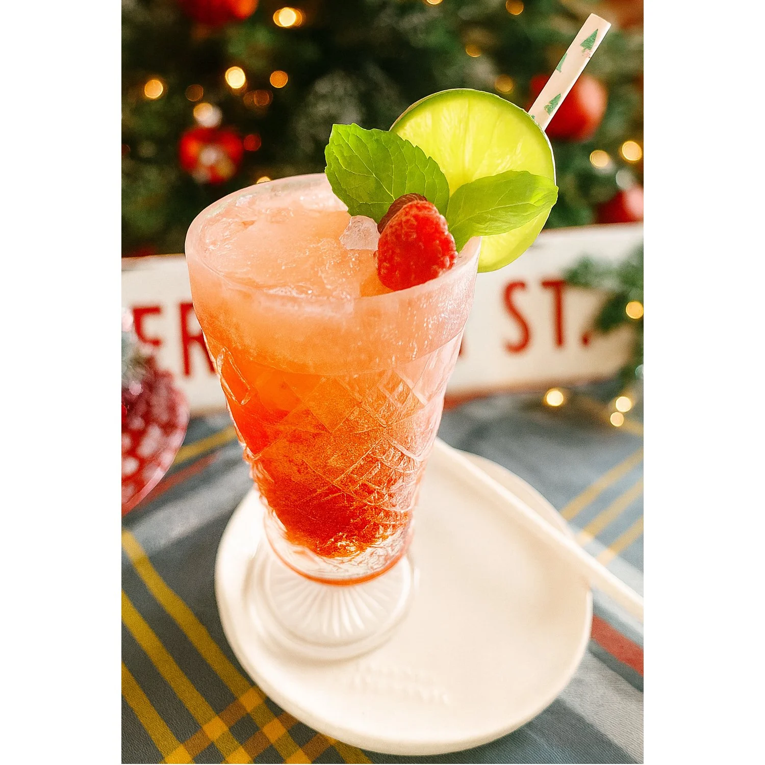 White Chocolate Raspberry Dirty Soda garnished with raspberry, lime, and mint.