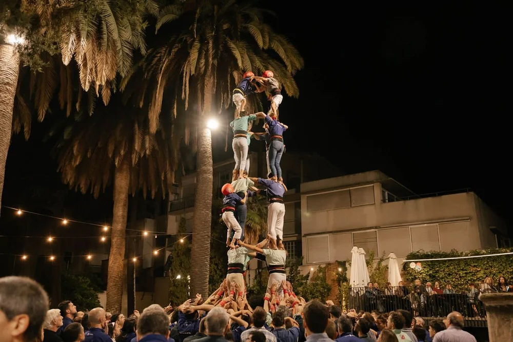 Castellers building a human tower at night in Vilafranca del Penedès
