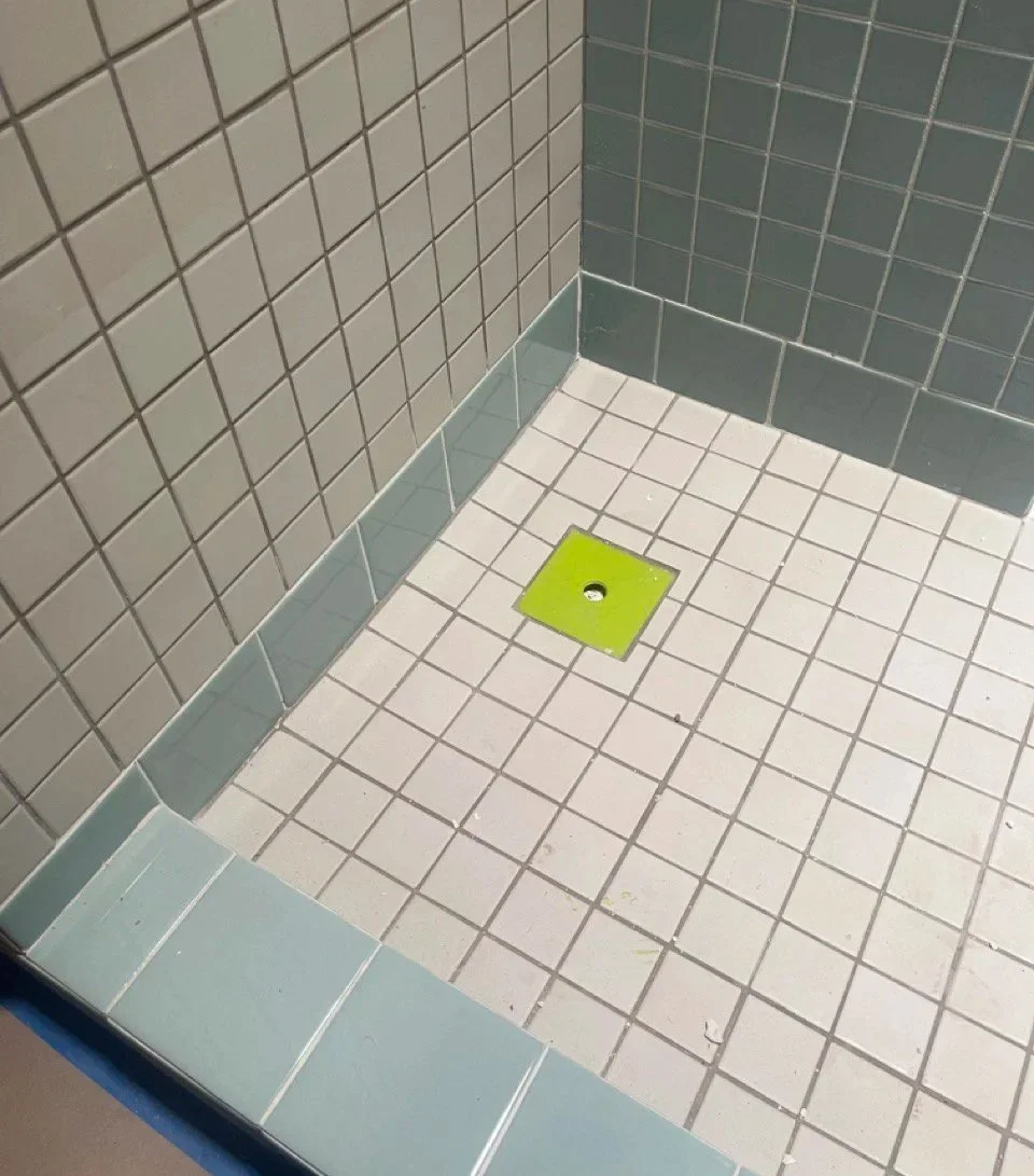 modern upscale primary bathroom design for boutique hospitality project in Palm Springs featuring custom floating vanity, recessed shelving, walk-in shower with custom soap niche