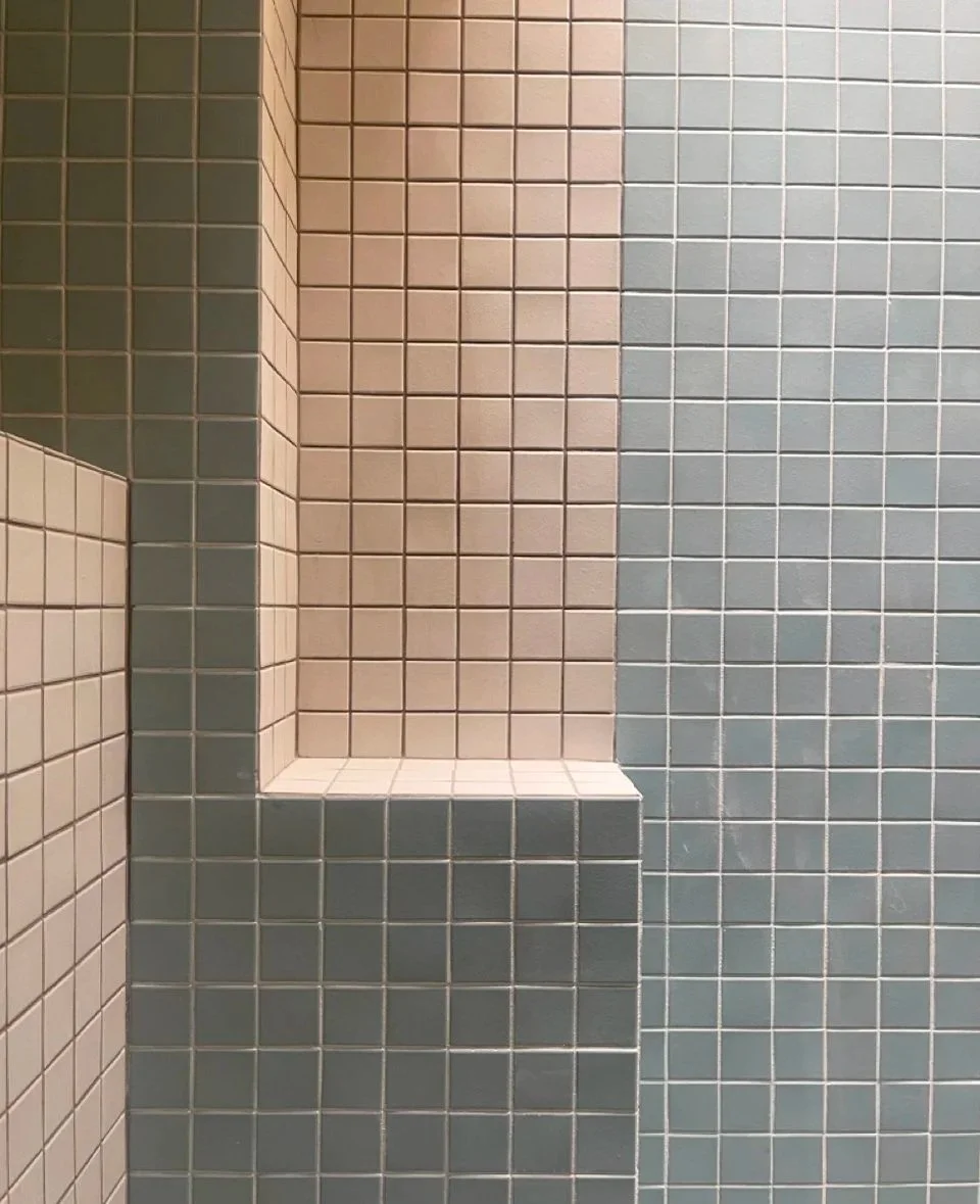 modern upscale primary bathroom design for boutique hospitality project in Palm Springs featuring custom floating vanity, recessed shelving, walk-in shower with custom soap niche