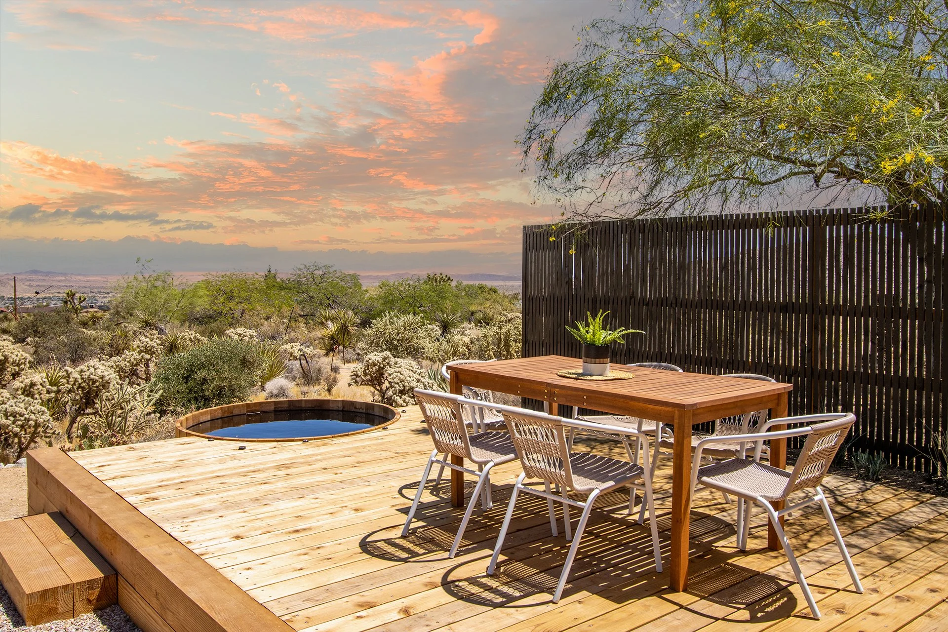 Backyard design featuring multi-level wood deck overlooking vast desert landscape with outdoor dining, integrated cedar spa and privacy fence.
