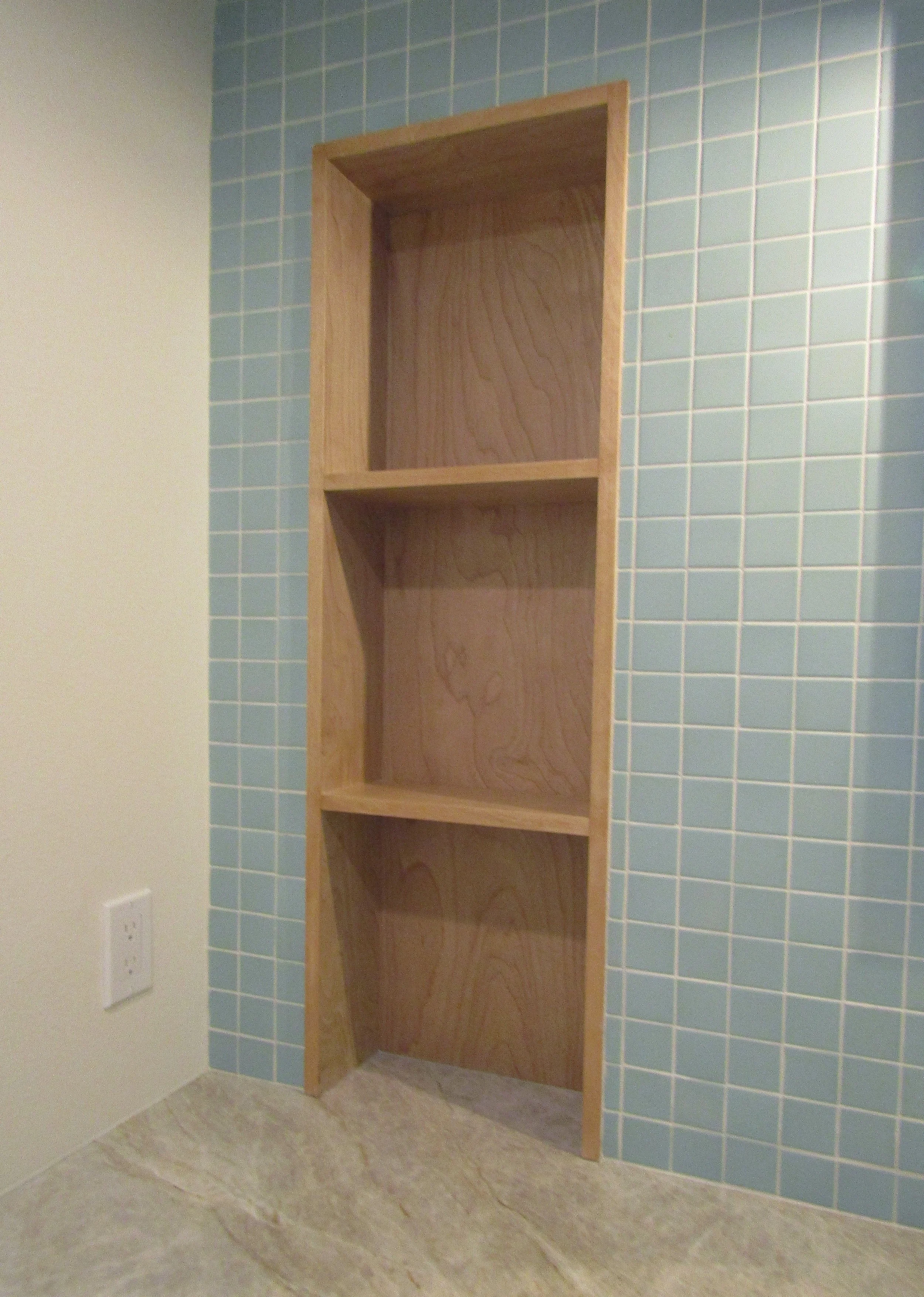 modern upscale primary bathroom design for boutique hospitality project in Palm Springs featuring custom floating vanity, recessed shelving, walk-in shower with custom soap niche