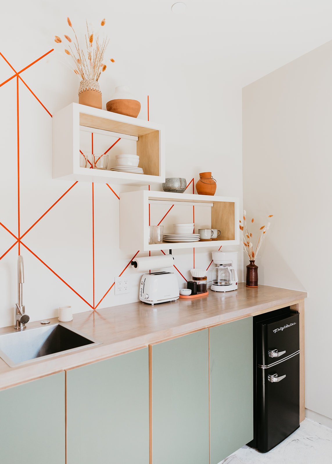 fun kitchen design with green cabinets for desert inspired property for vacation home design