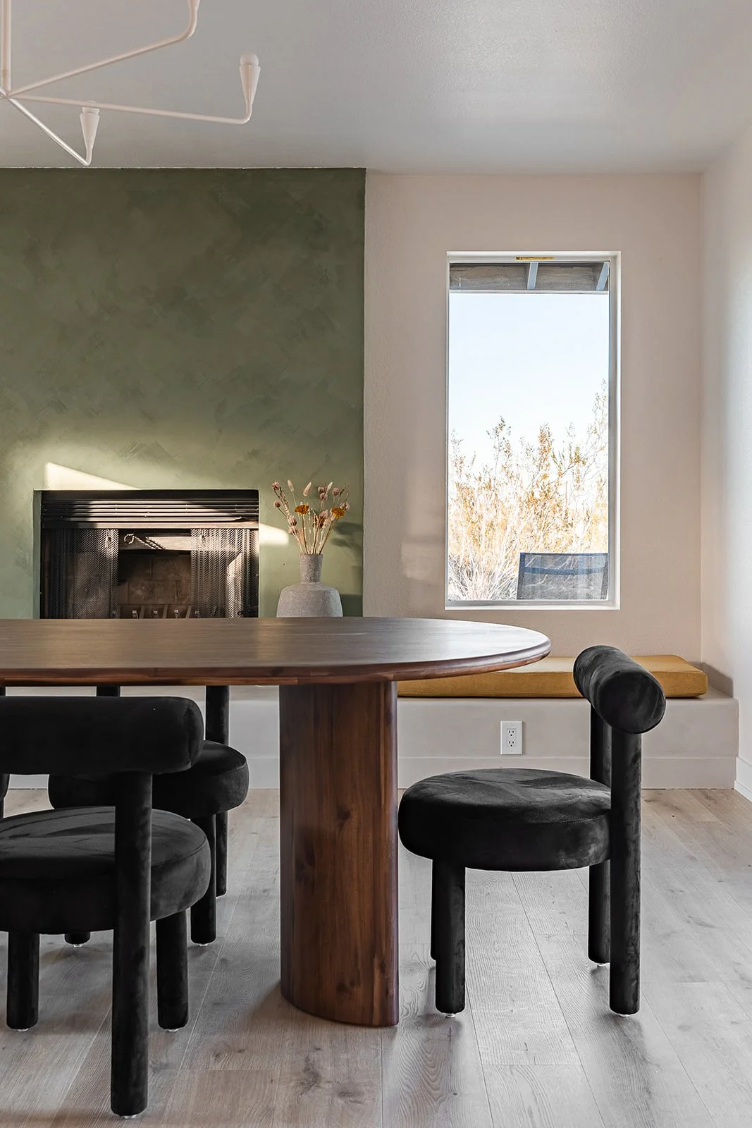 modern earthy dining room interior design with olive plaster fireplace by design build firm joshua tree california for vacation home design