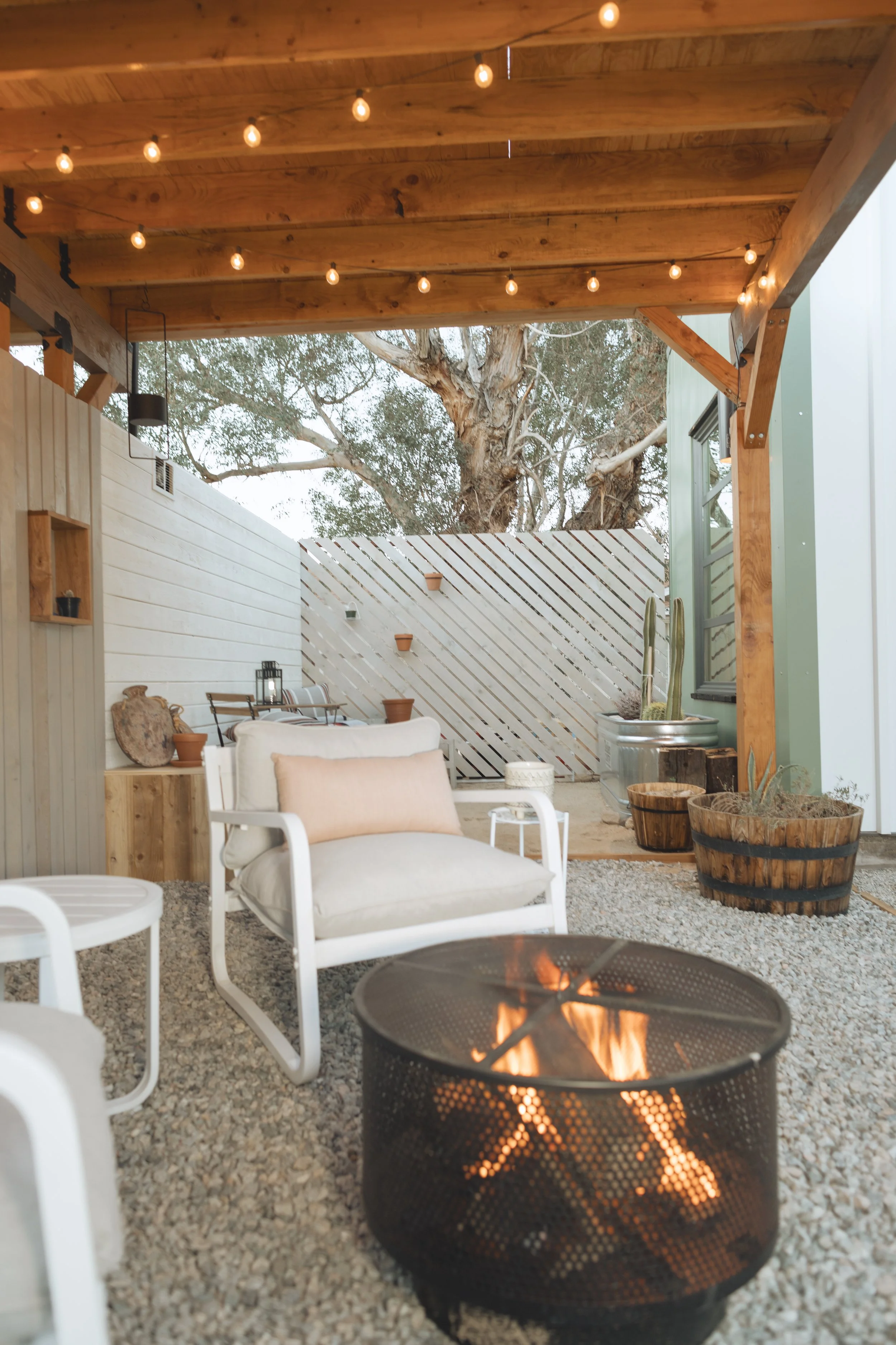 cute outdoor patio area with string lights for desert property by design build studio in joshua tree california for vacation home design