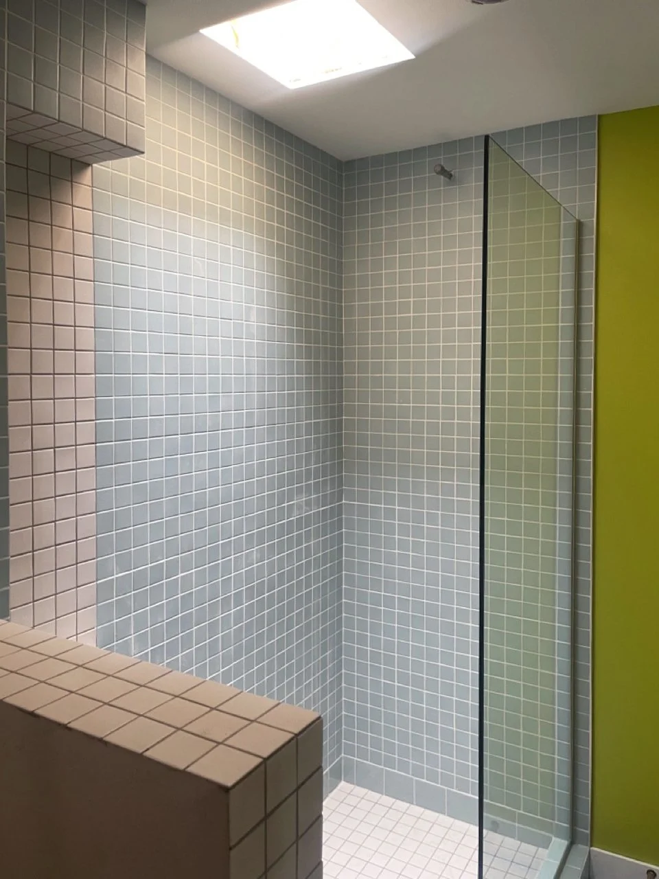 modern upscale primary bathroom design for boutique hospitality project in Palm Springs featuring custom floating vanity, recessed shelving, walk-in shower with custom soap niche