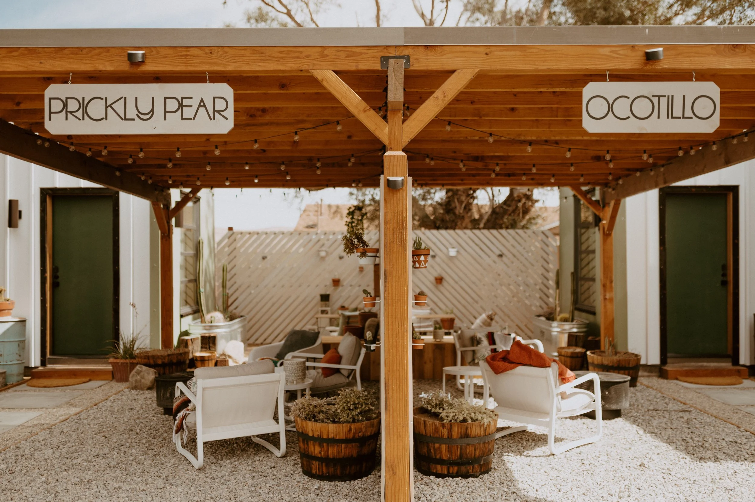 cute outdoor patio area with string lights for desert property by design build studio in joshua tree california for vacation home design