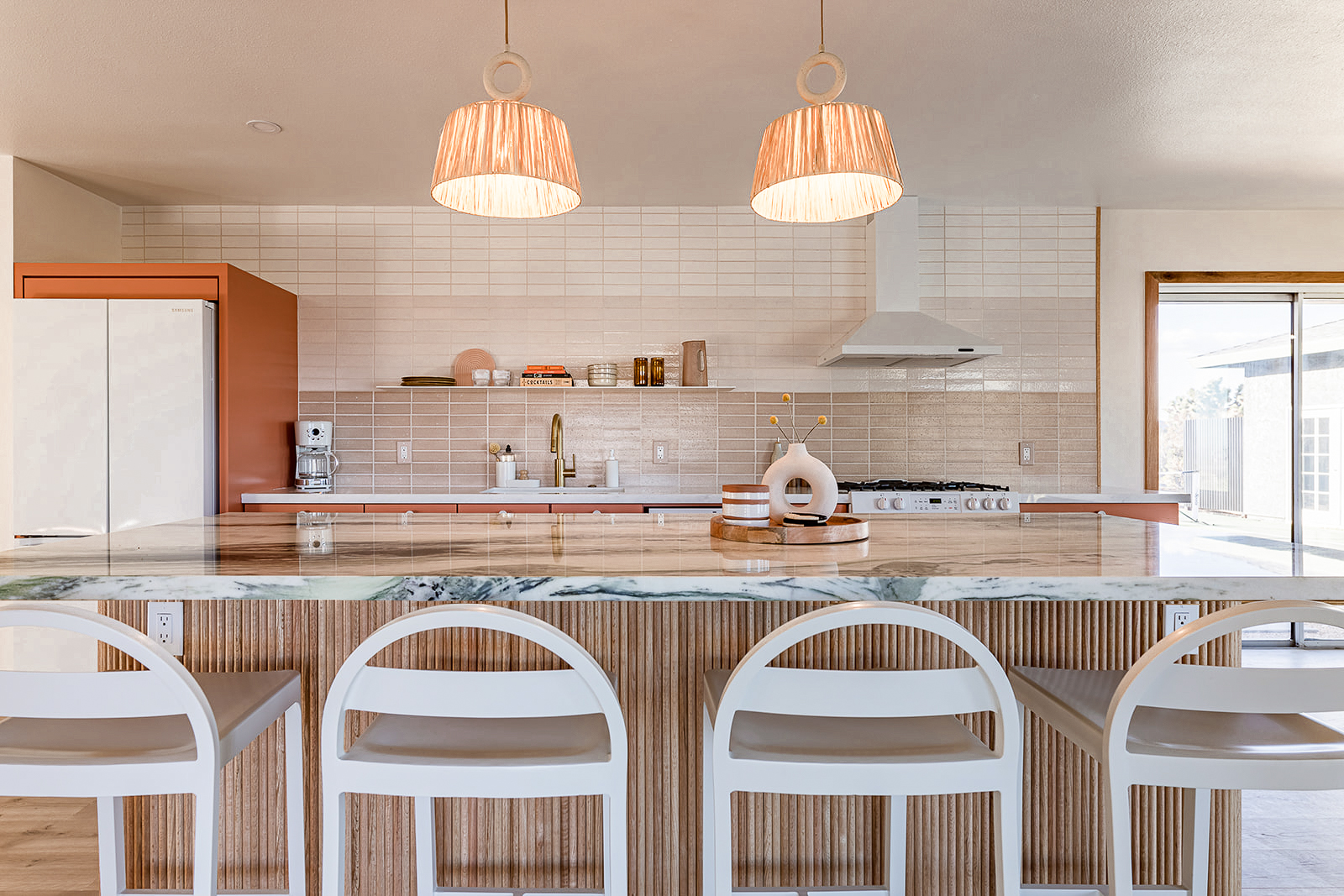 modern and airy pink kitchen and dining room interior design with custom elements by design build studio in joshua tree california for vacation home design