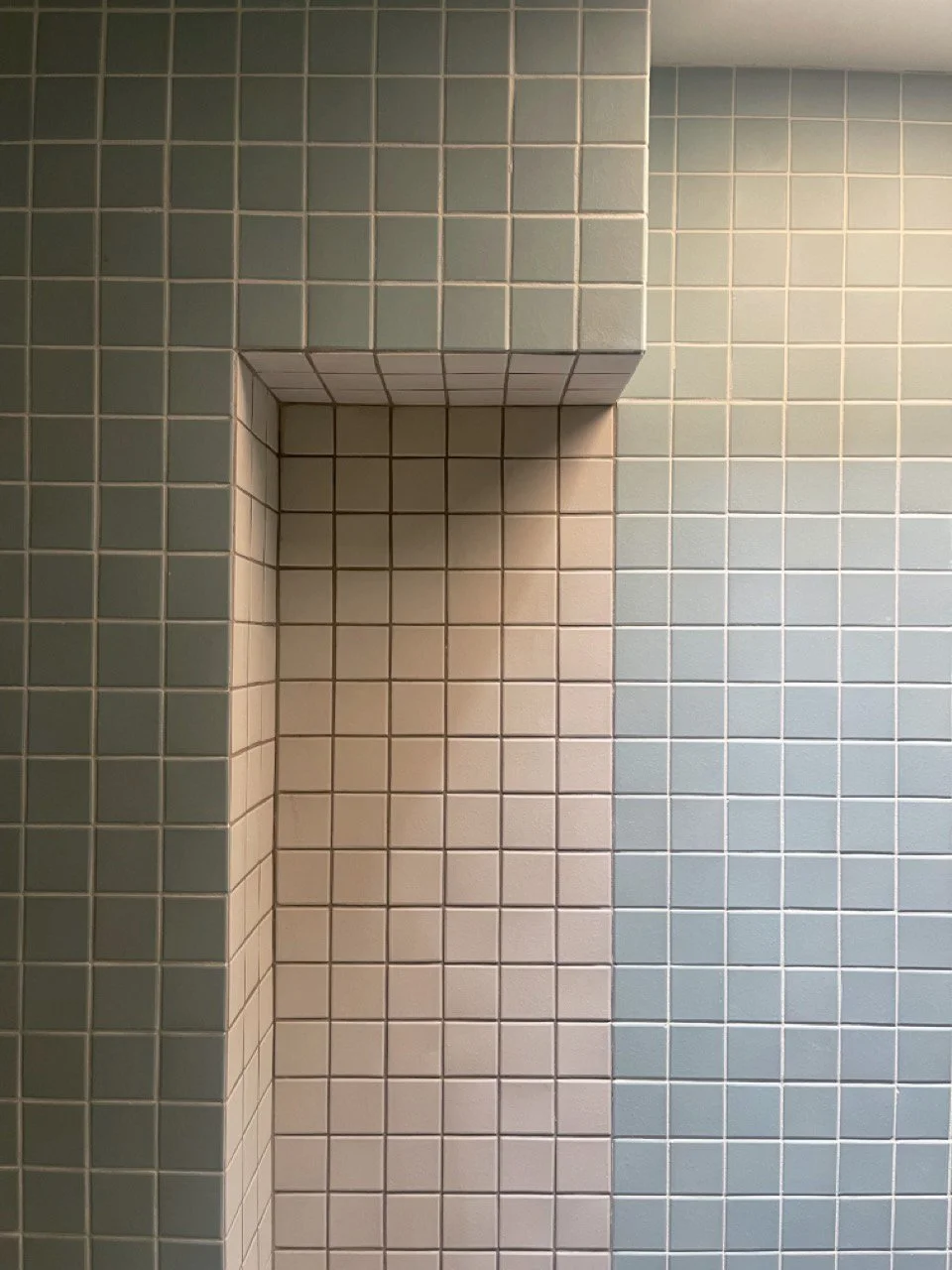 modern upscale primary bathroom design for boutique hospitality project in Palm Springs featuring custom floating vanity, recessed shelving, walk-in shower with custom soap niche