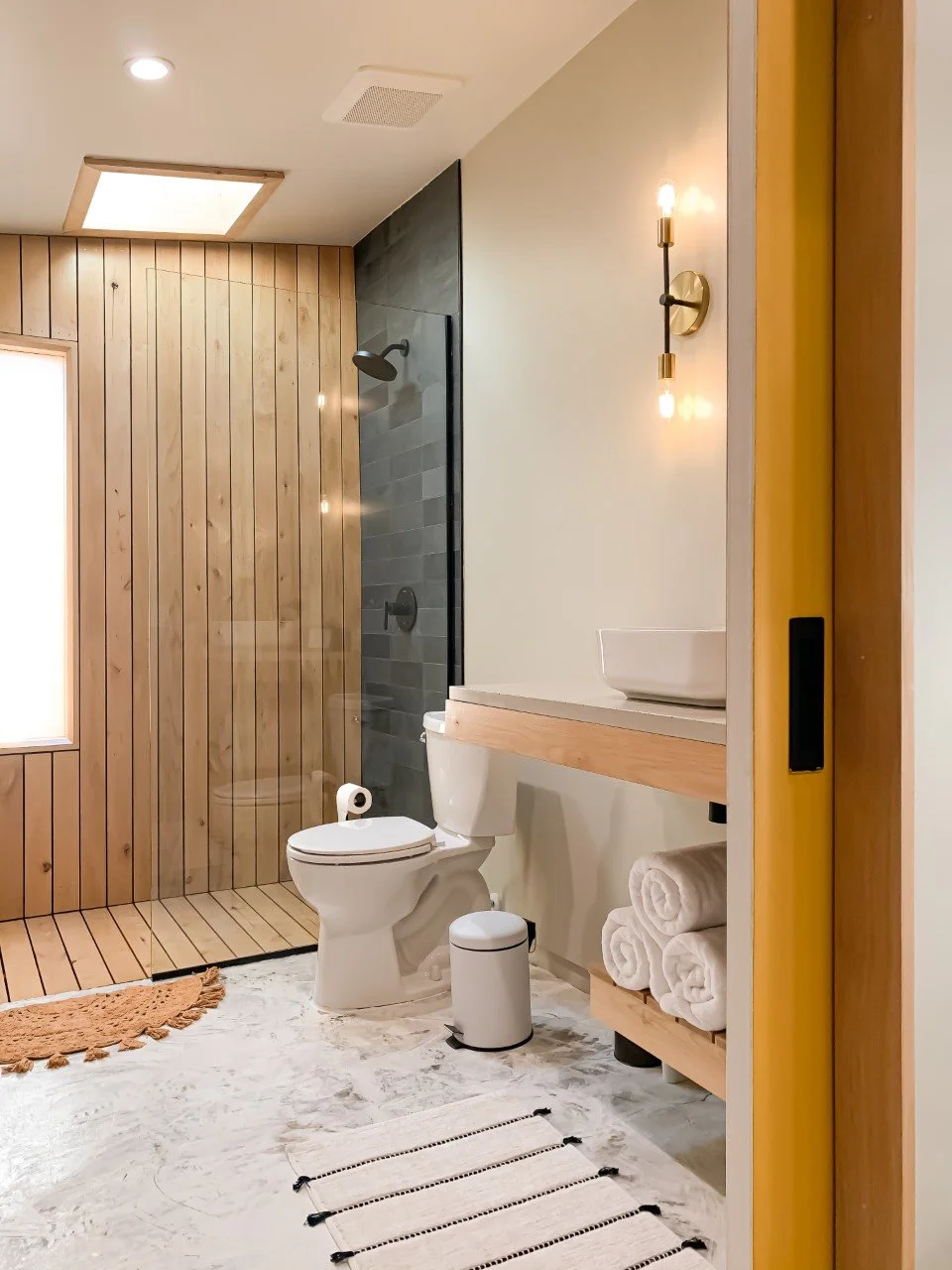 modern and custom interior design of bathroom with floating vanity and shelf for vacation rental use by design build firm in joshua tree for vacation home design