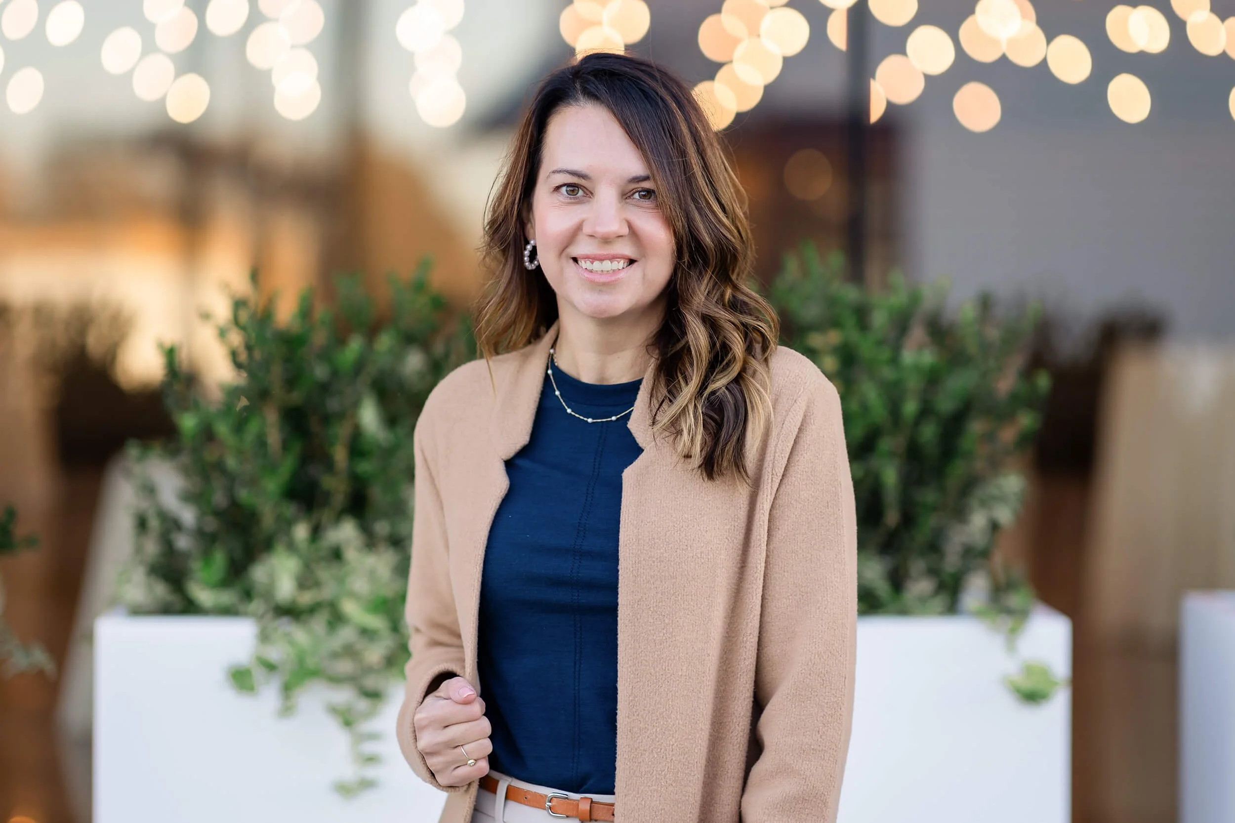 Dr. Tabitha Rossini outside a bistro wearing a coat and smiling