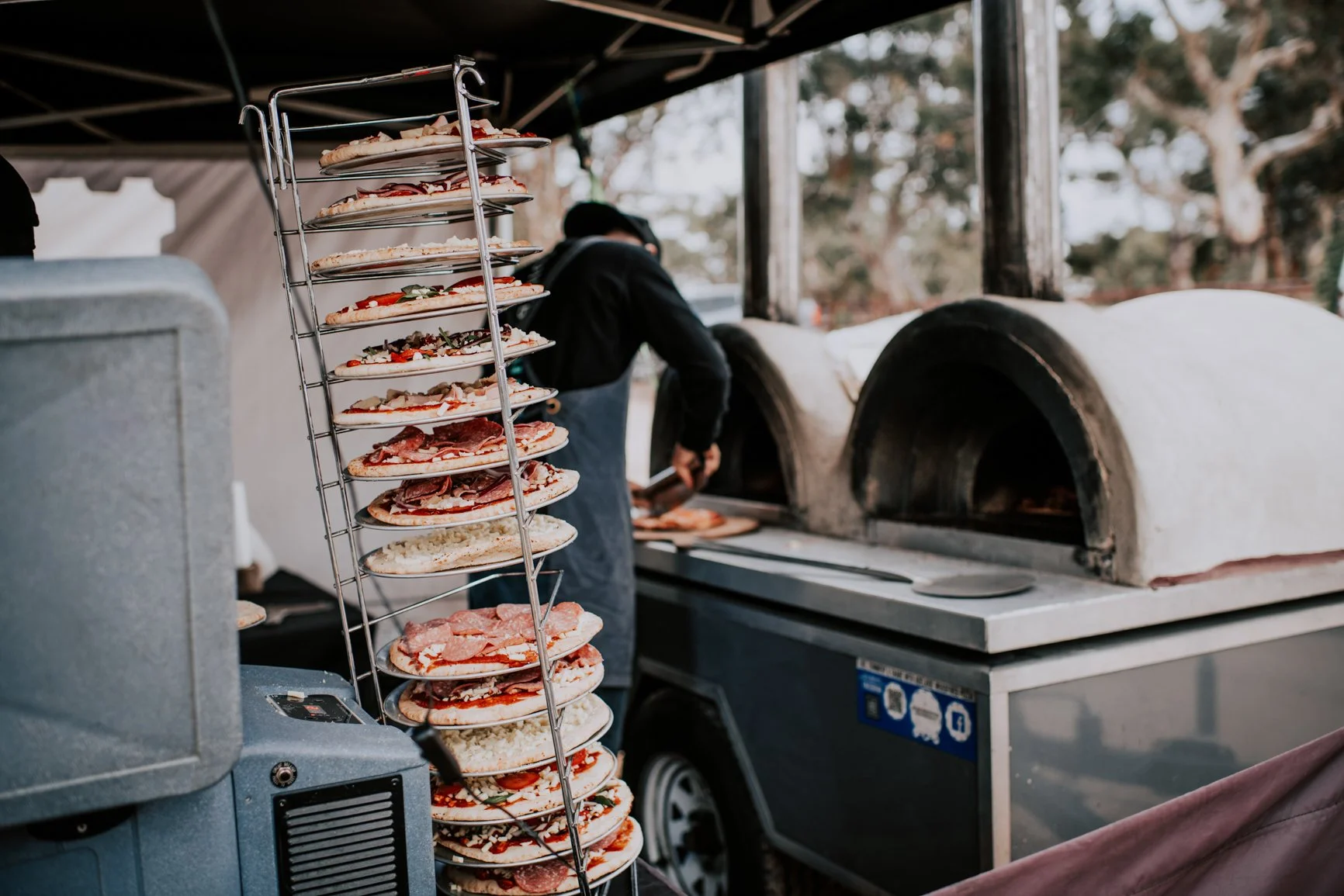 Food truck with pizzas stacked ready for the oven