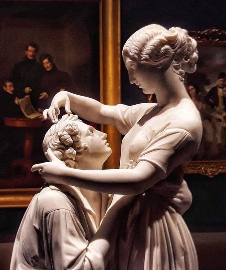 Marble bust of a man and woman embracing in museum