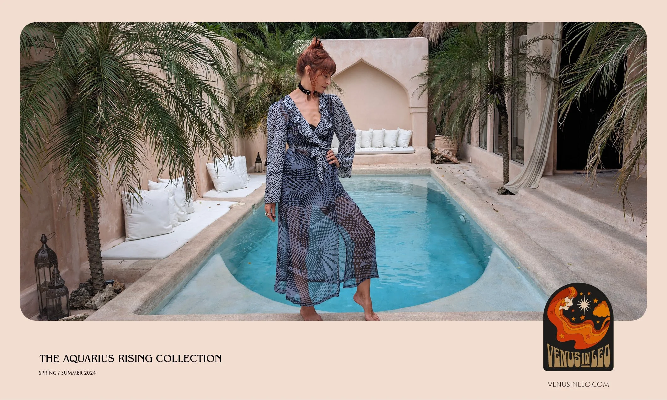 A woman stands barefoot by a pool with a sheer, patterned blue dress, surrounded by palm trees and white cushions on a beige outdoor patio, advertising the Aquarius Rising Collection for Spring/Summer 2024.